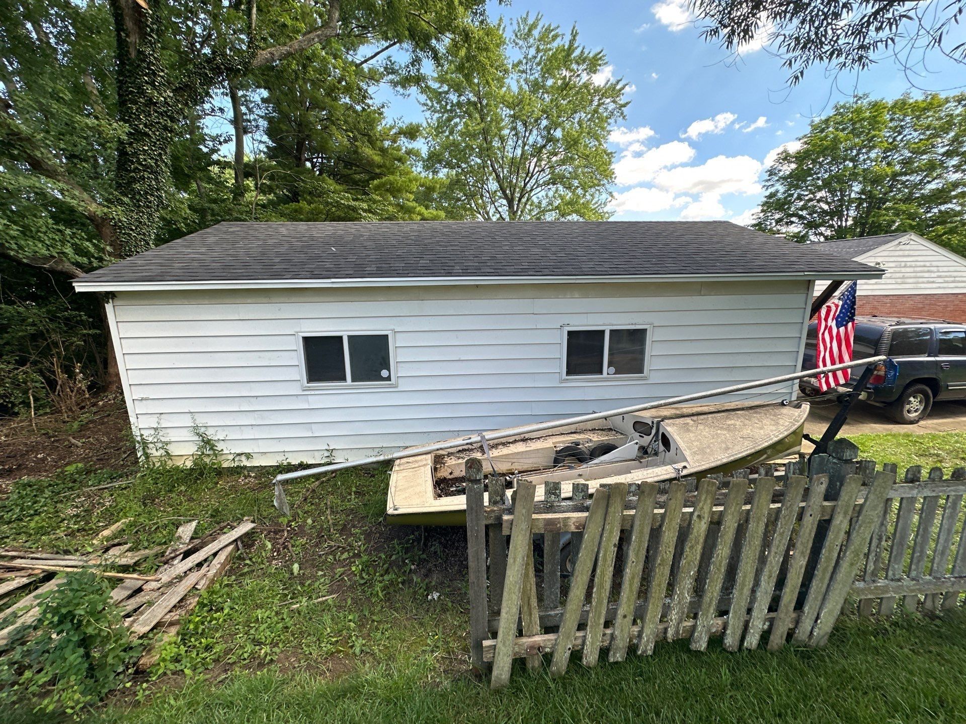 Back of the garage, boat and picket fence