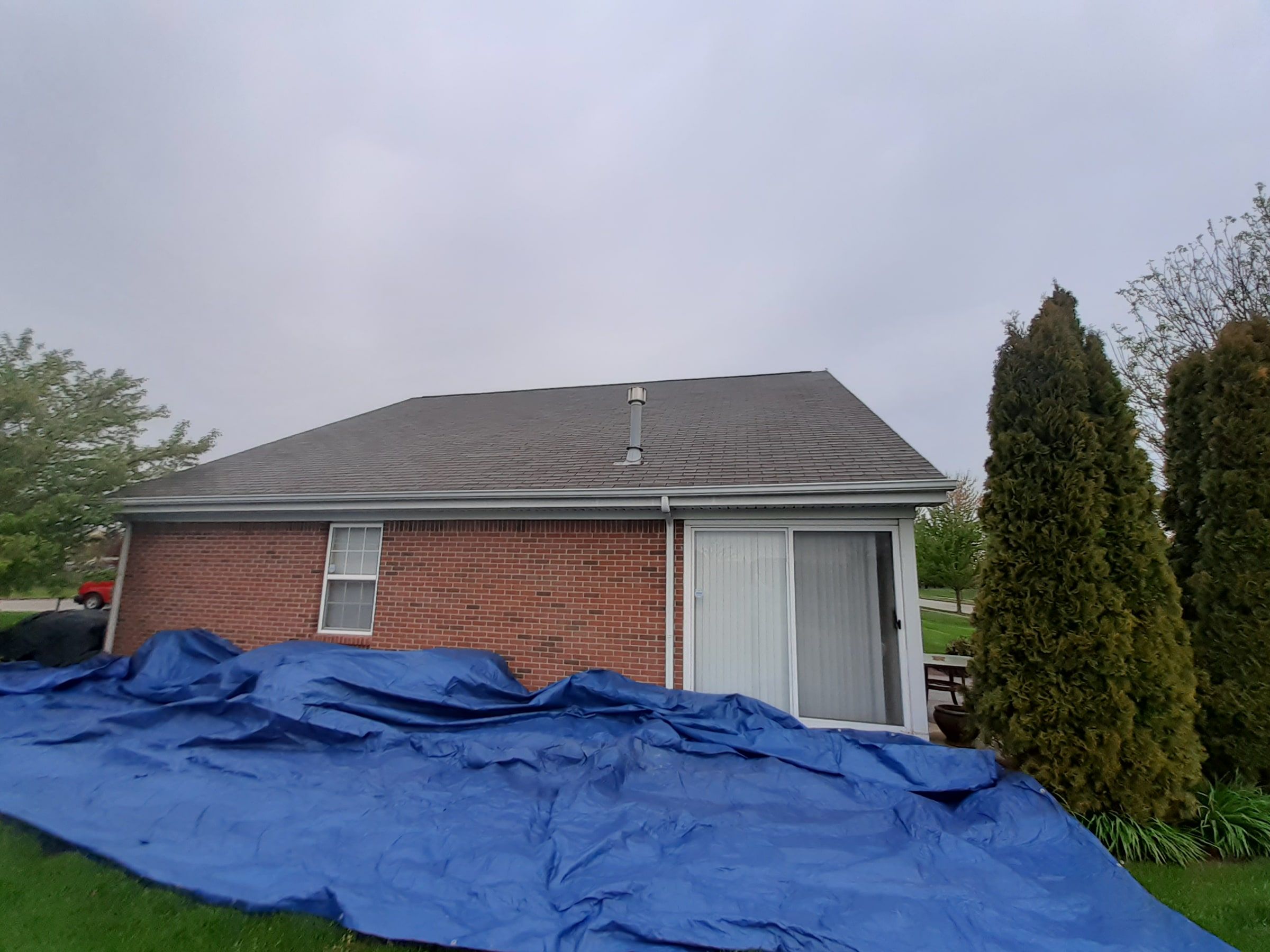 Rear of the brick house and ground tarps