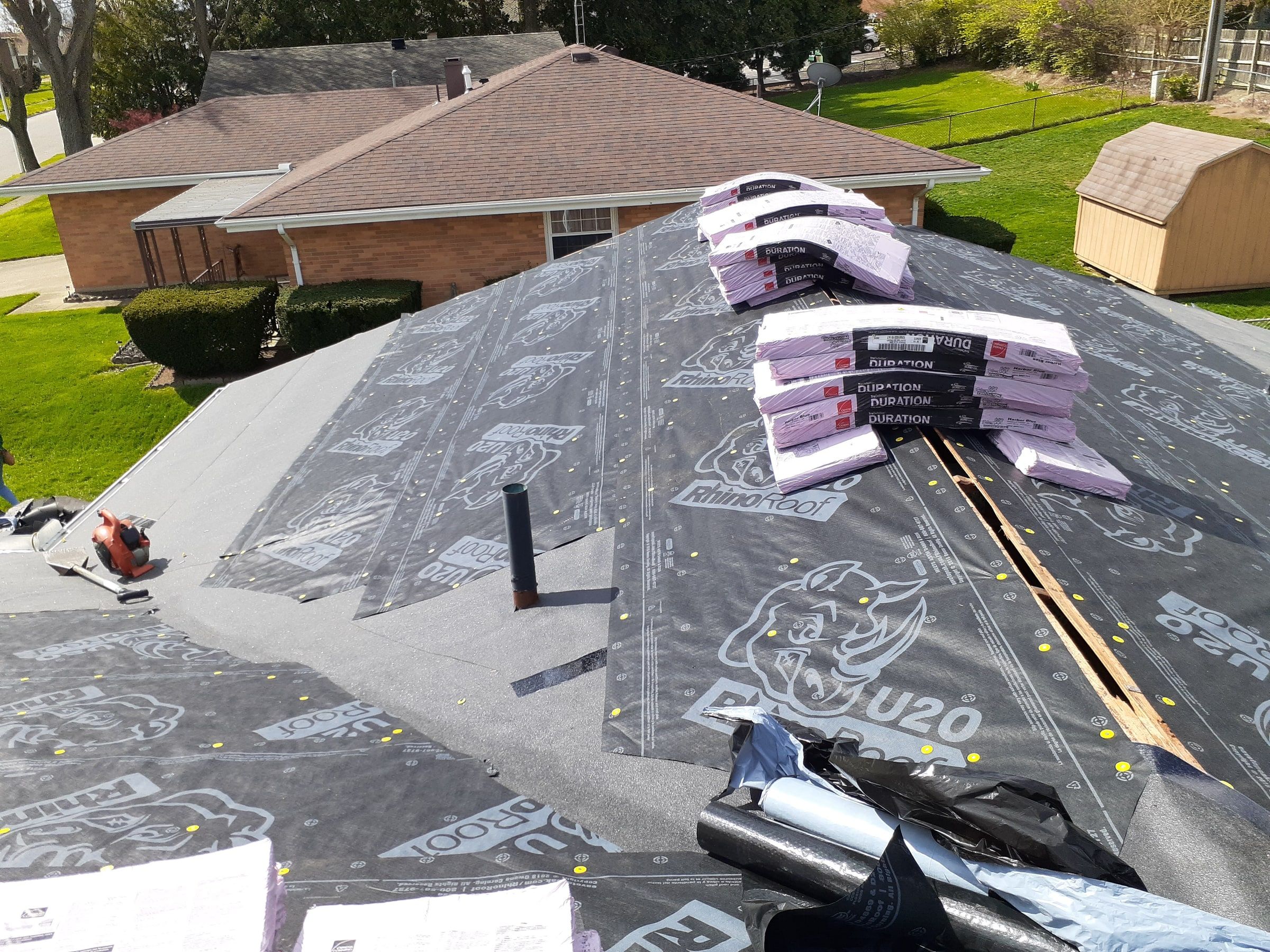 Owens Corning Duration bundles staged on RhinoRoof U20 near the ridge, Kettering, Ohio.