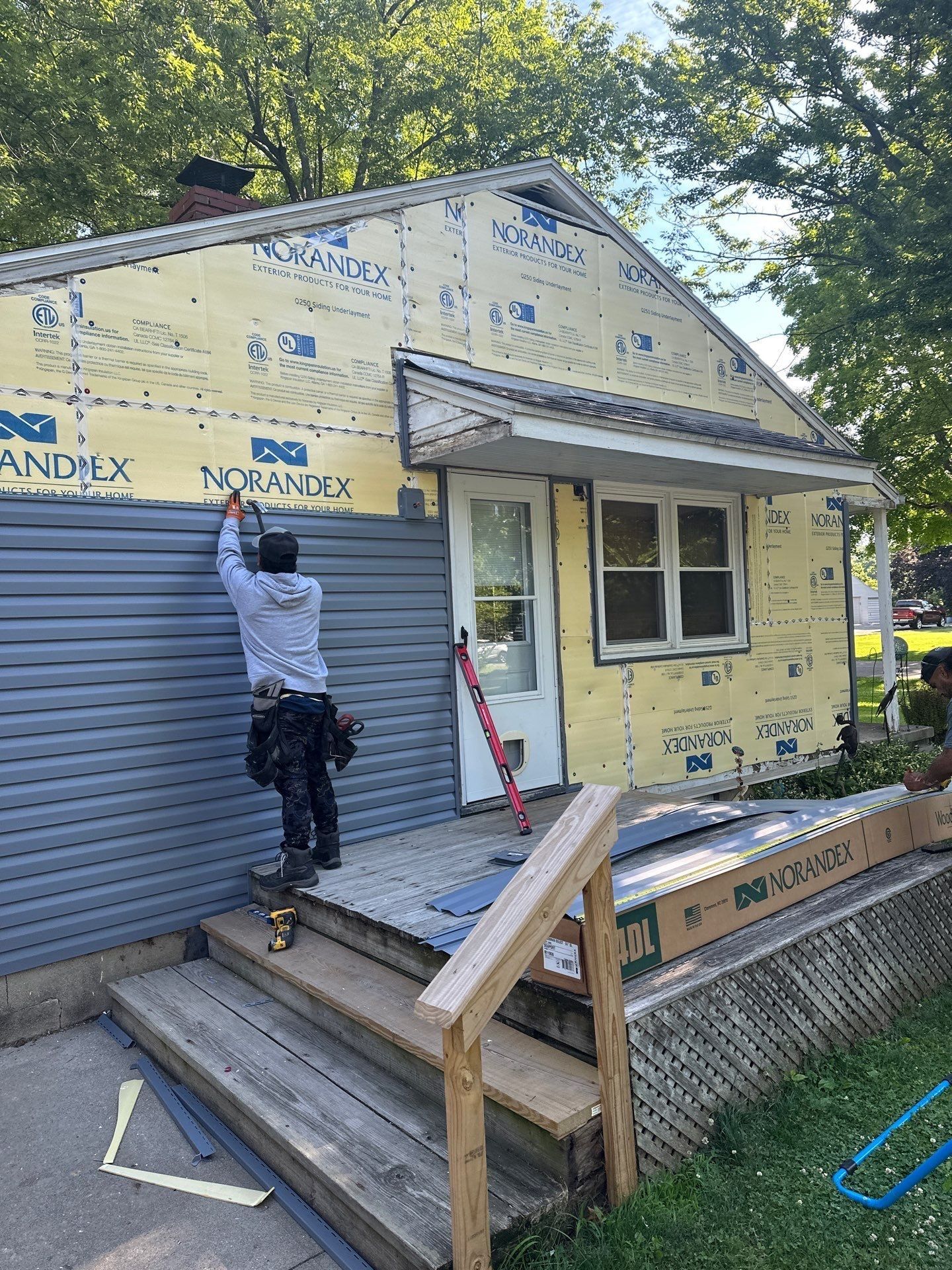 New vinyl siding going on over the insulation board at the back door, Beavercreek, Ohio.