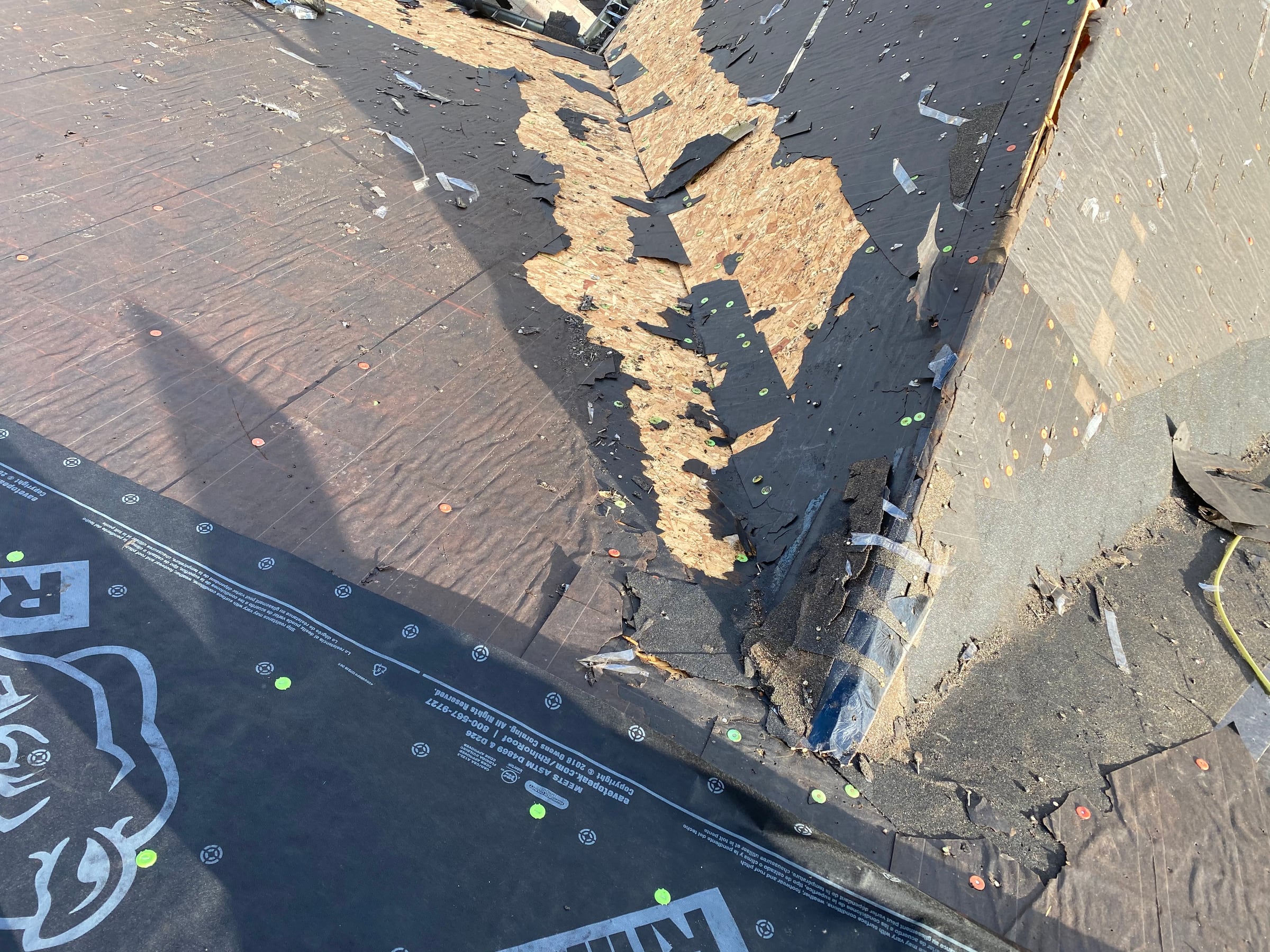 Old shingles and felt along a hip