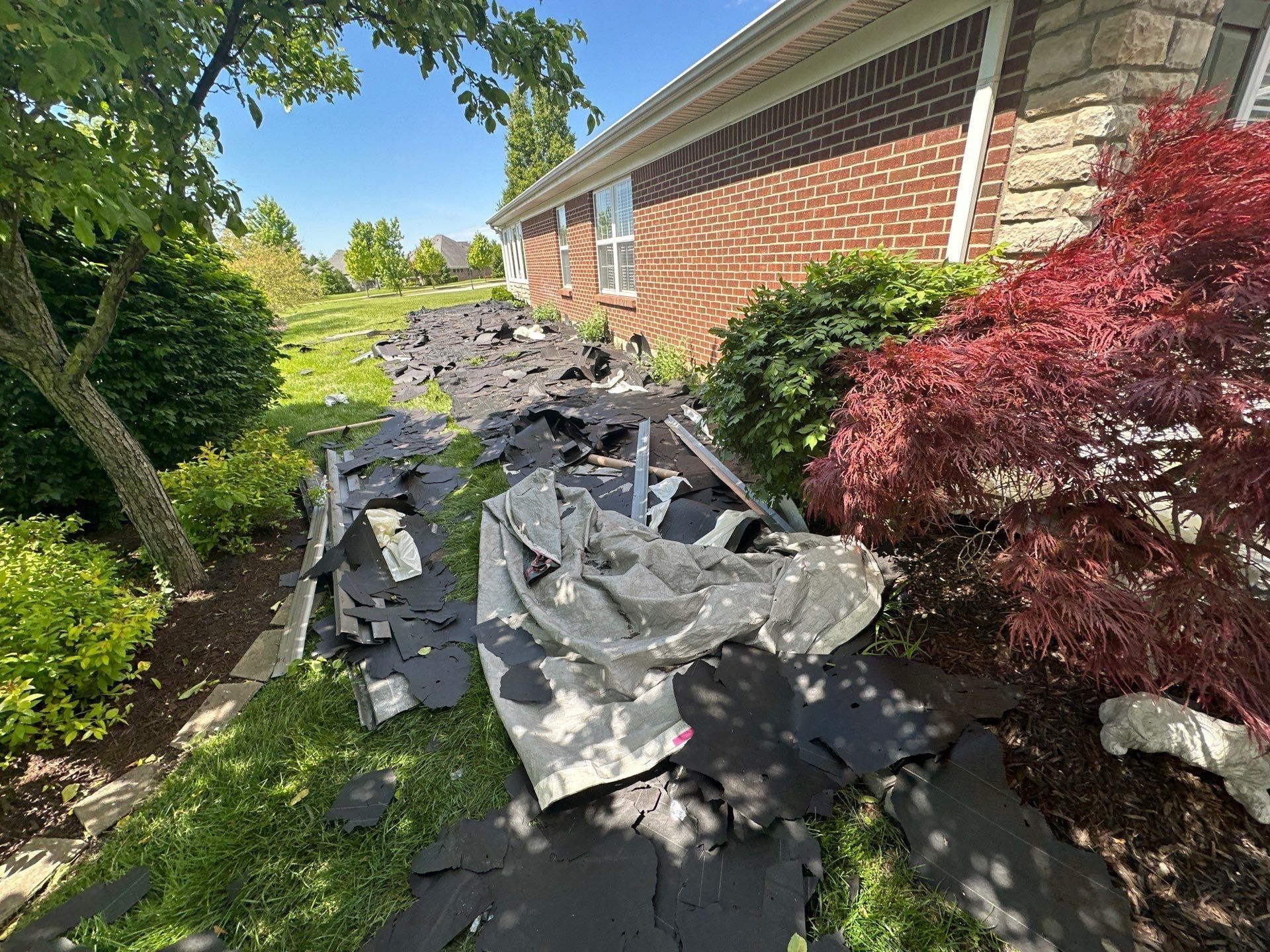 Tear-off debris on lawn and bed