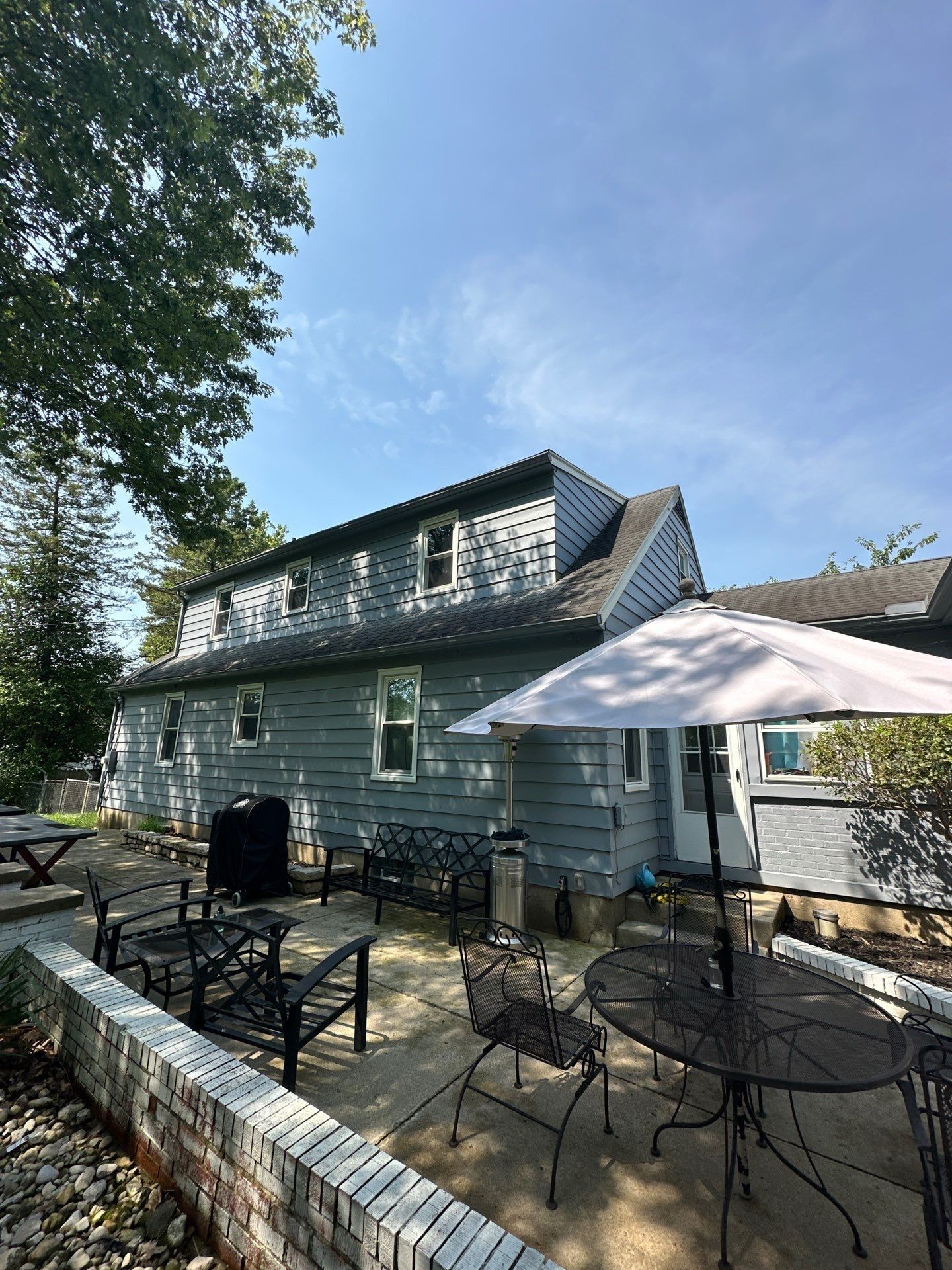 The back patio and umbrella below the dormer, Beavercreek, Ohio.