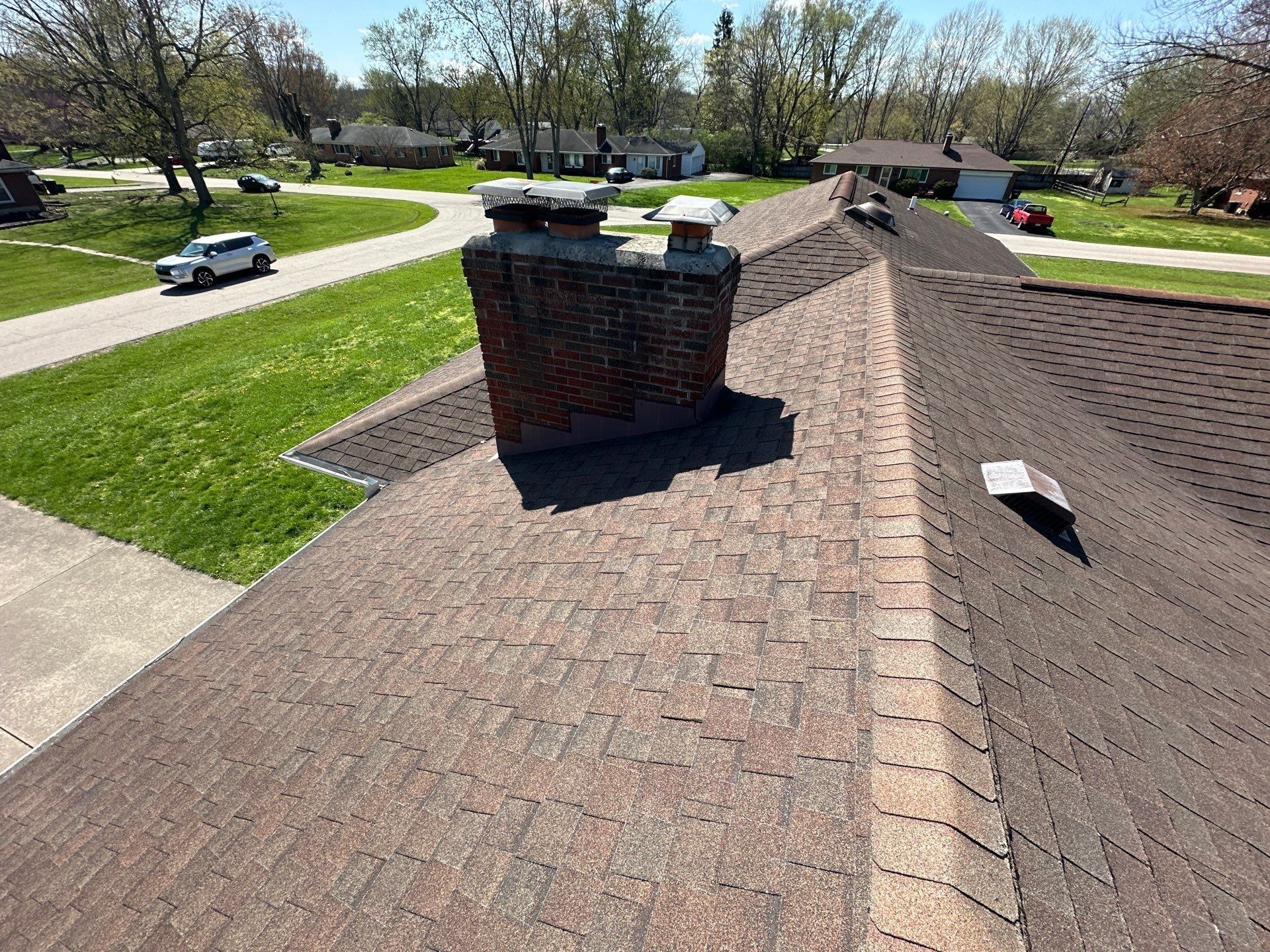Old roof slope with the brick chimney and a box vent, Beavercreek, Ohio.
