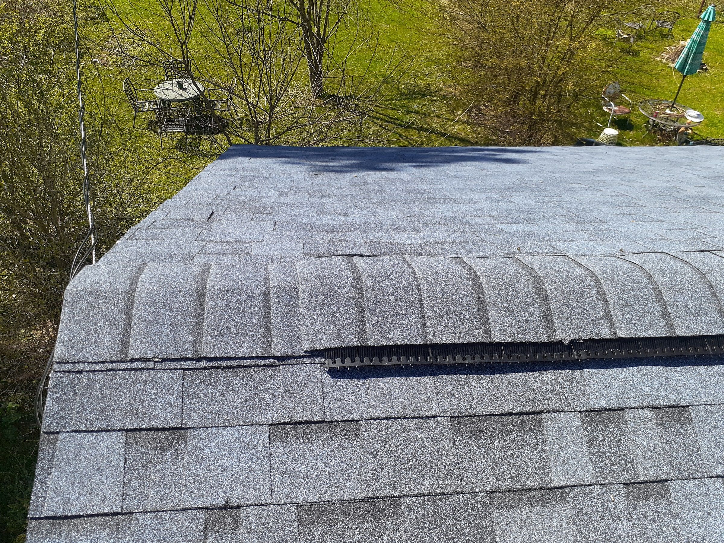 Ridge cap going on over the new ridge vent at the end of the roof, Yellow Springs, Ohio.