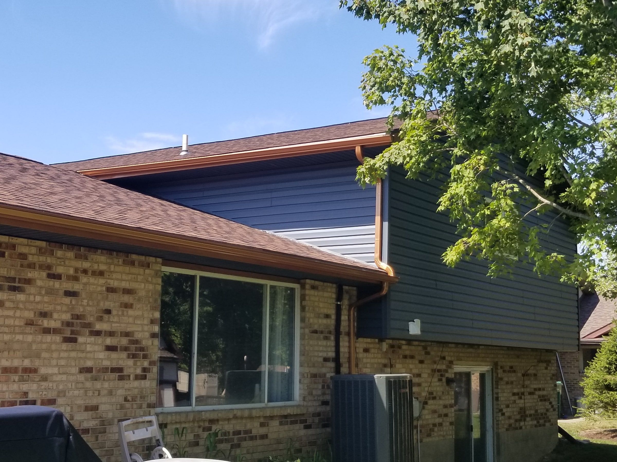 The upper story in blue-gray siding above the back roof, Beavercreek, Ohio.
