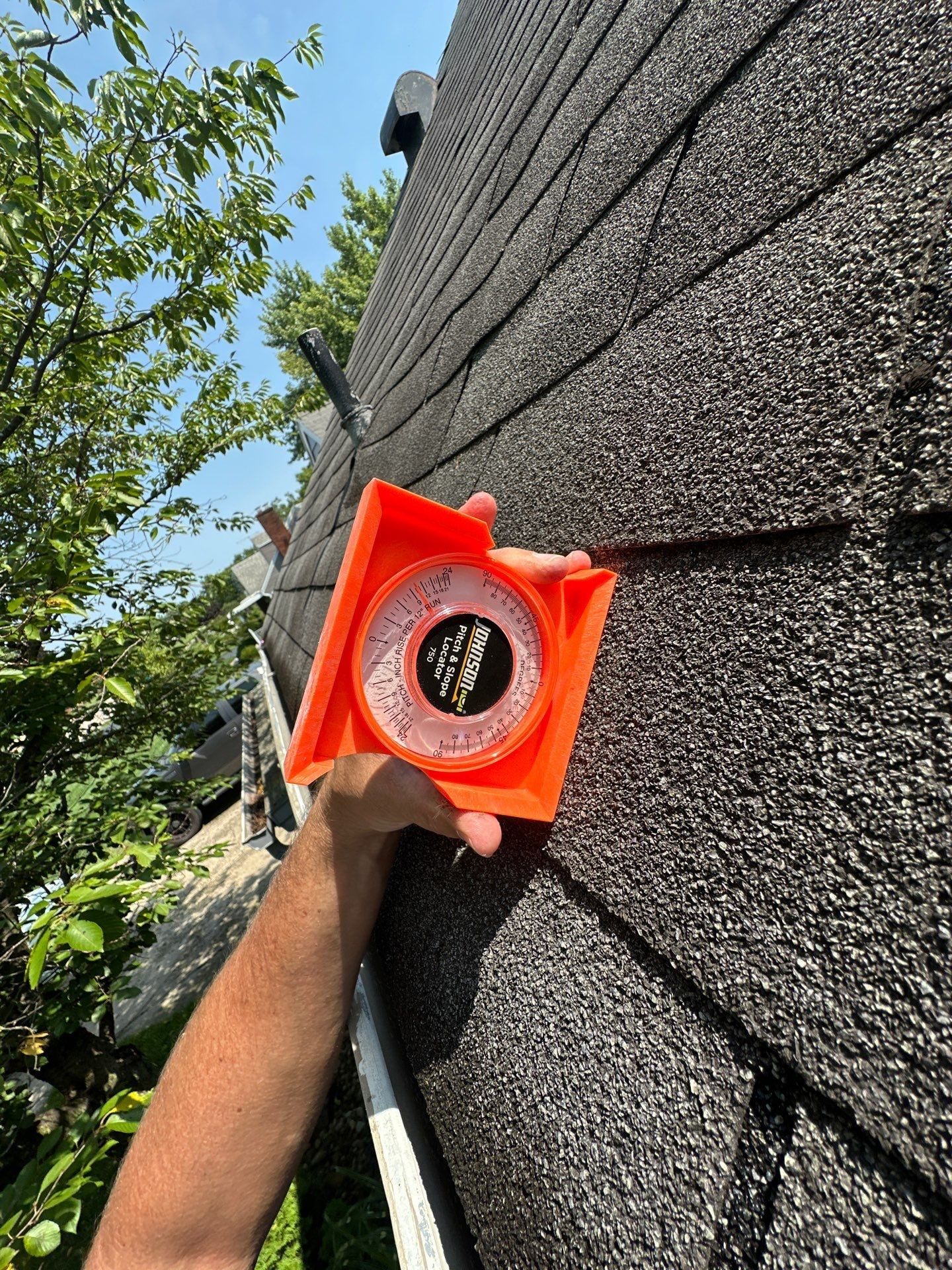 A pitch gauge on the old shingles to read the slope of the roof, Beavercreek, Ohio.