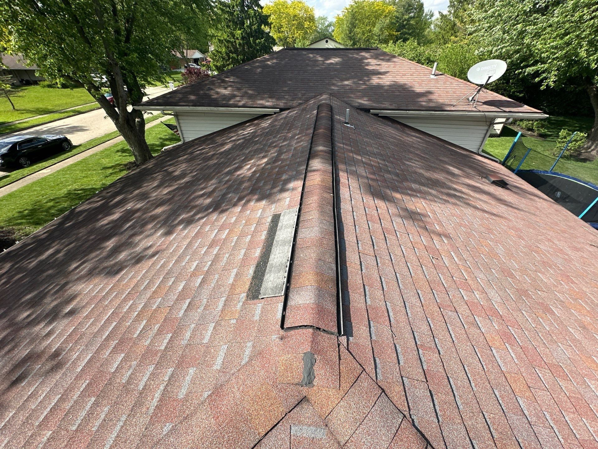 Sample shingles for the ITEL test laid beside the ridge to compare with the old roof, Dayton, Ohio.