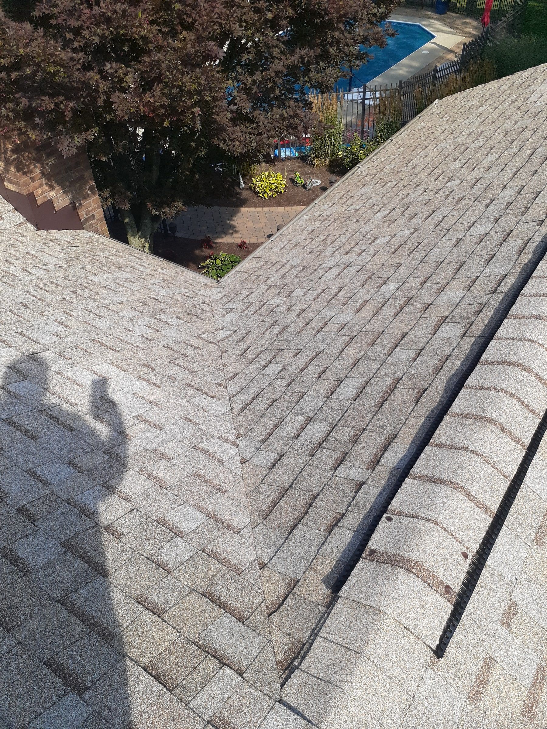 Finished valley next to a capped ridge vent over the pool yard, Jamestown, Ohio.