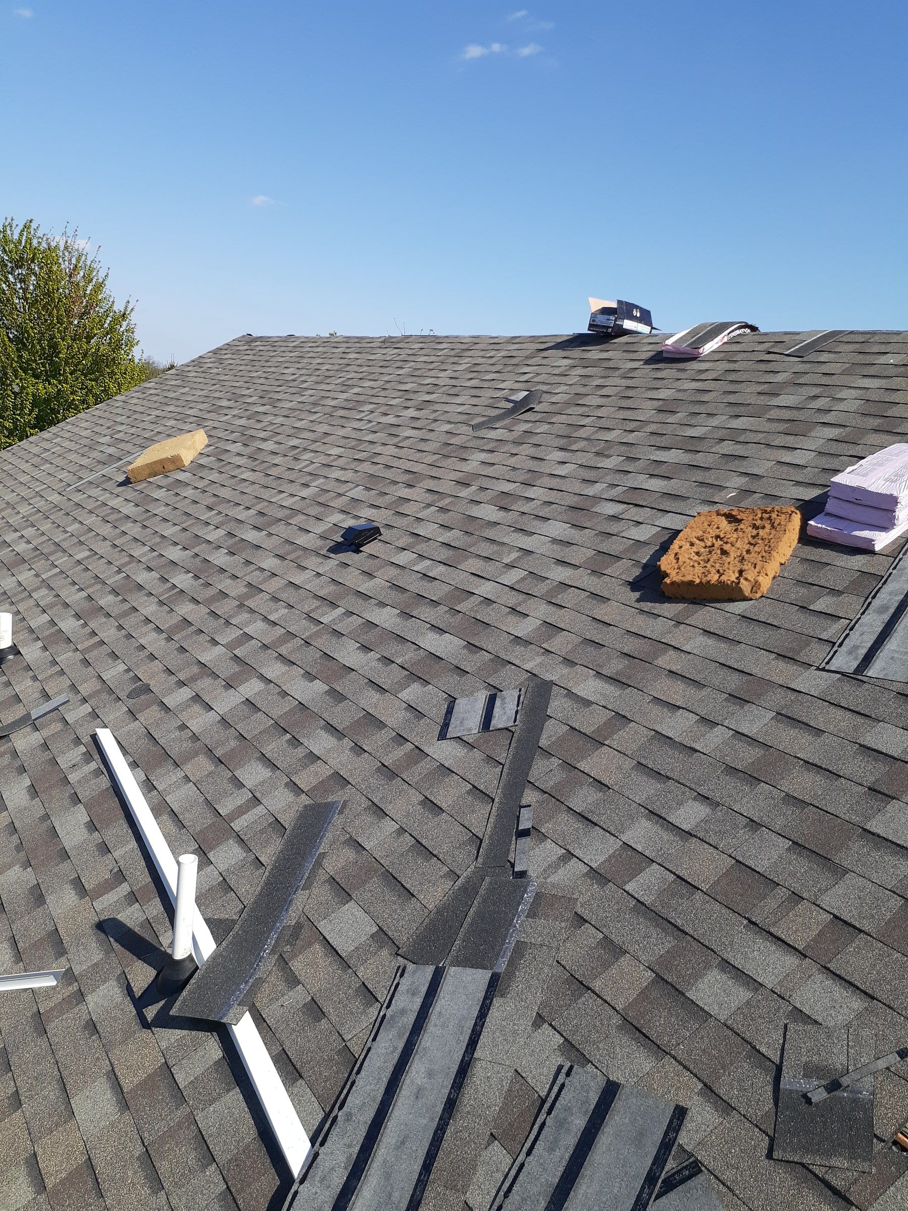 New shingles going on, with bundles still staged near the top, Xenia, Ohio.