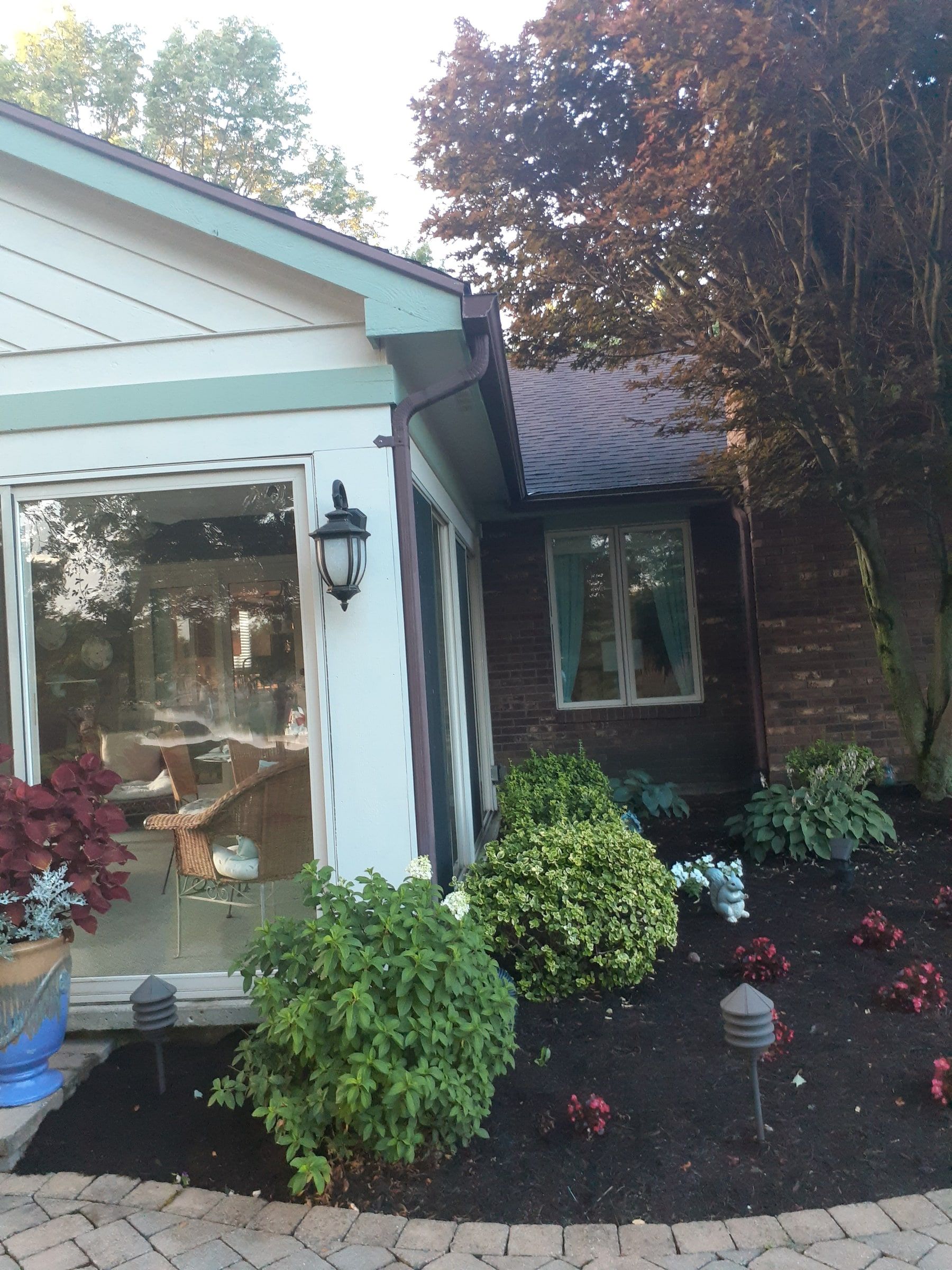 Sunroom corner and garden bed beside the back of the house, Jamestown, Ohio.