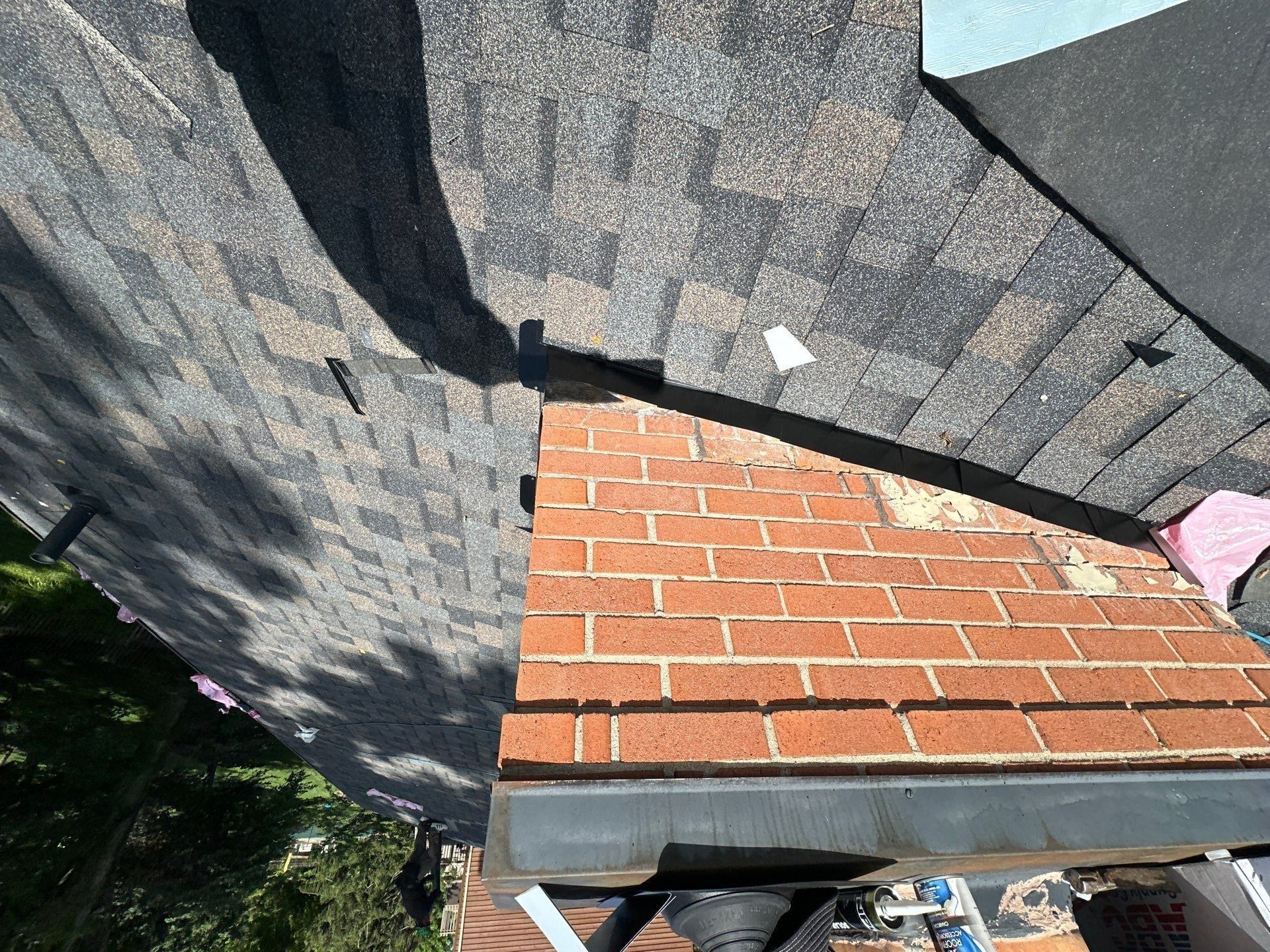 Shingles cut in around the brick chimney