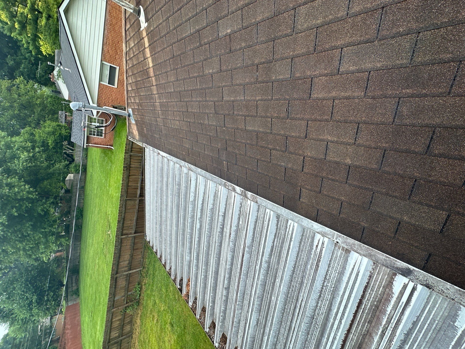 Metal patio cover meeting the edge of the shingle roof, Beavercreek, Ohio.