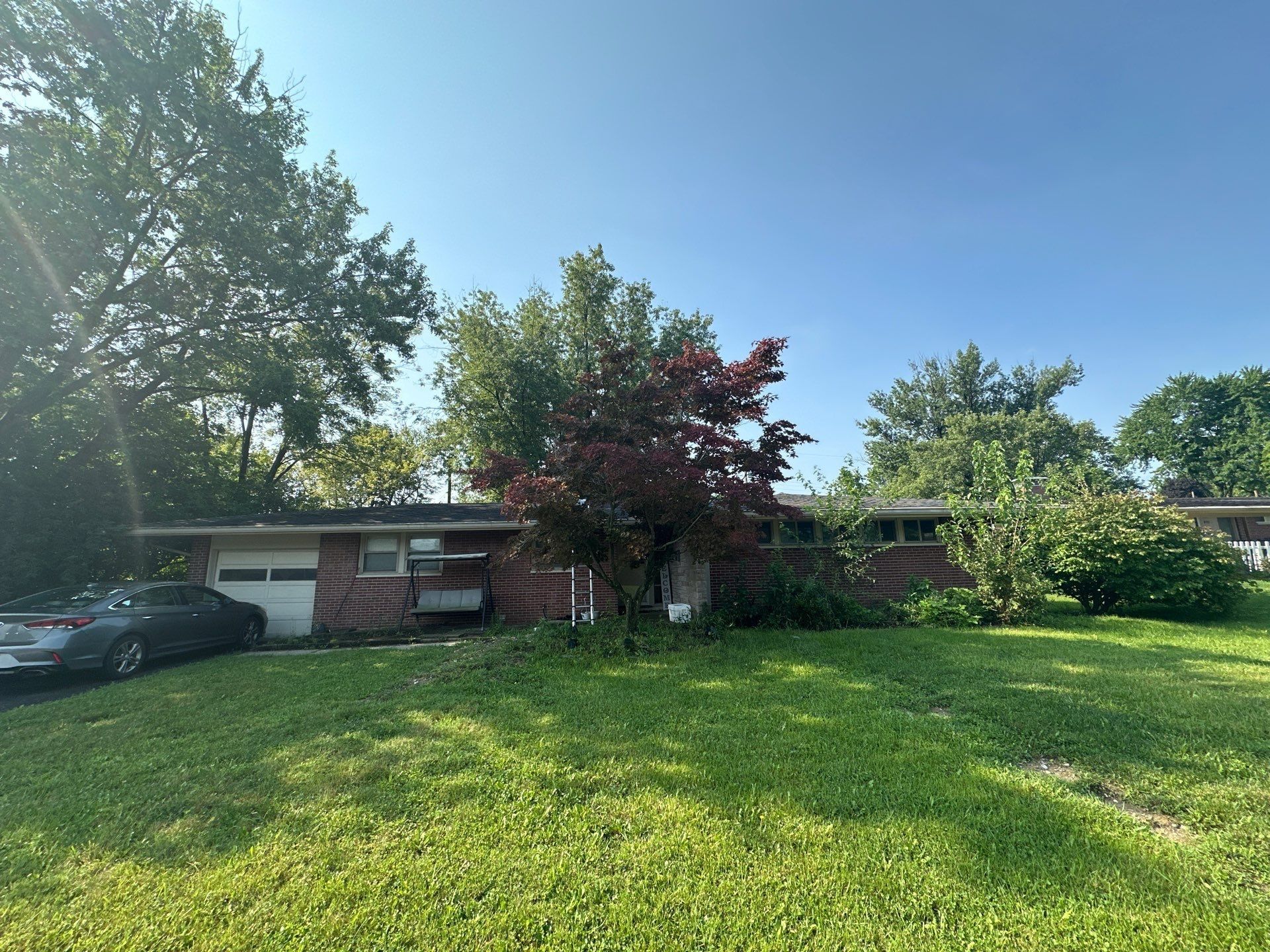The brick ranch from the front lawn at the August inspection, Kettering, Ohio.