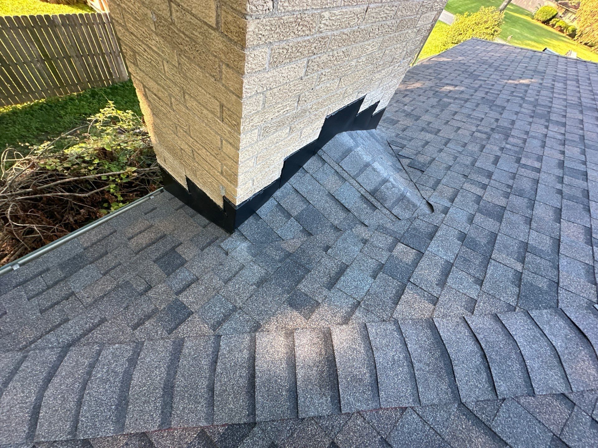 Finished chimney cricket with black stepped flashing and new shingles, Beavercreek, Ohio.