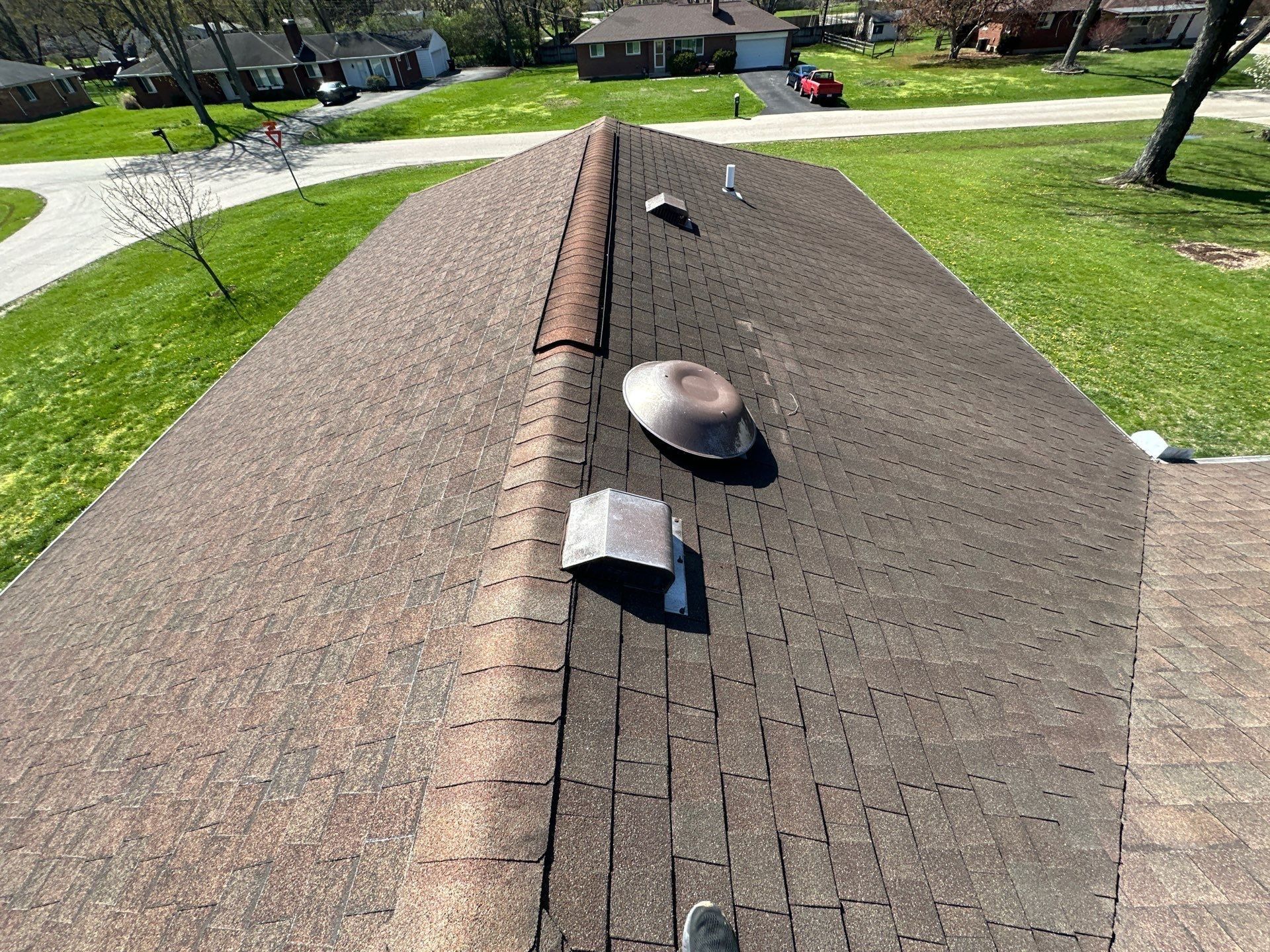 Round and square exhaust vents on the old shingle roof near the ridge, Beavercreek, Ohio.