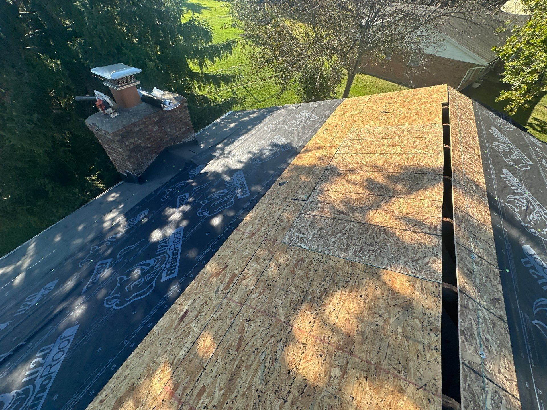 New OSB along the ridge, beside a slope already under underlayment, West Carrollton, Ohio.