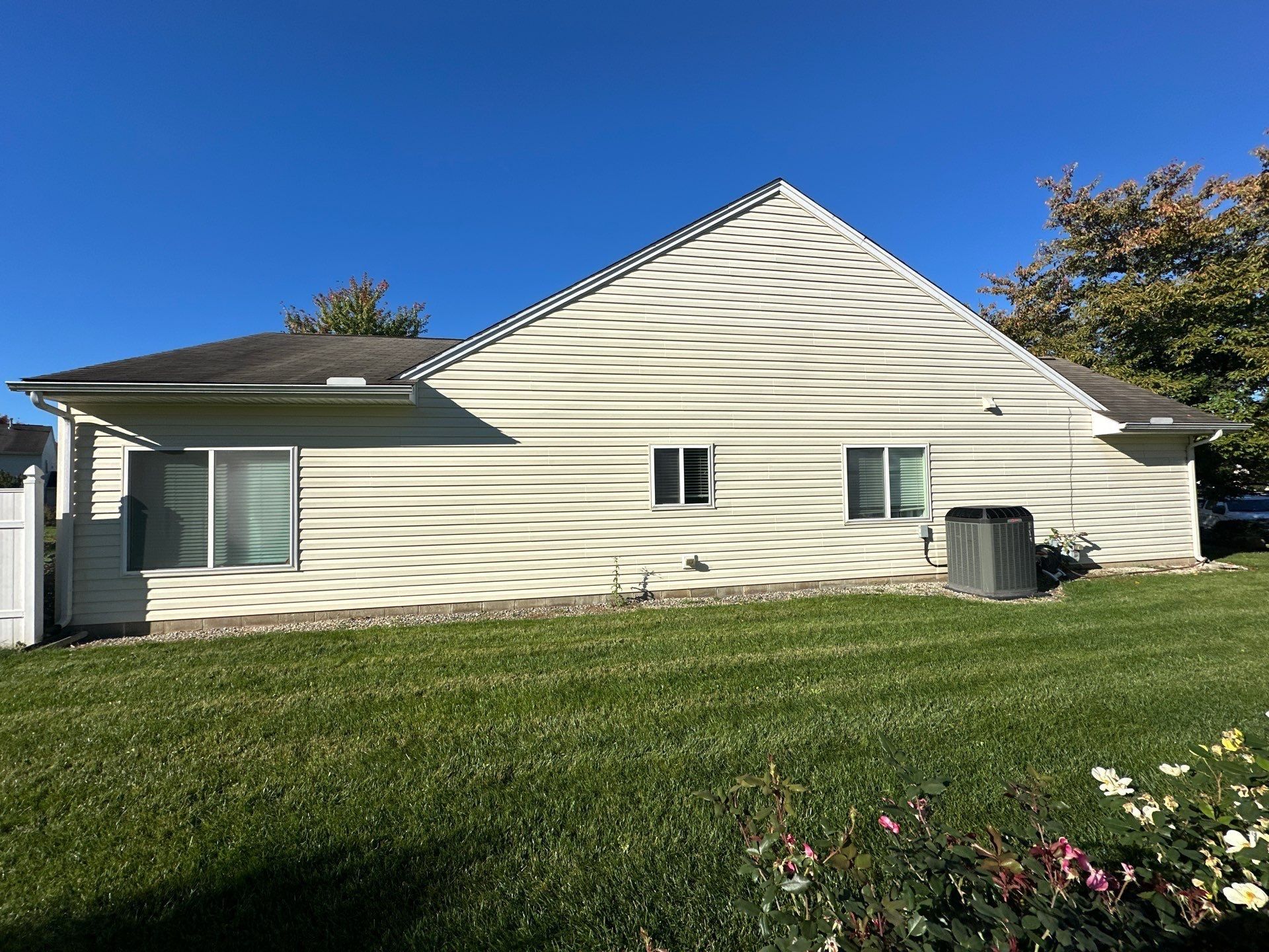The long side of the house with the old dark shingles above the vinyl siding, Beavercreek, Ohio.