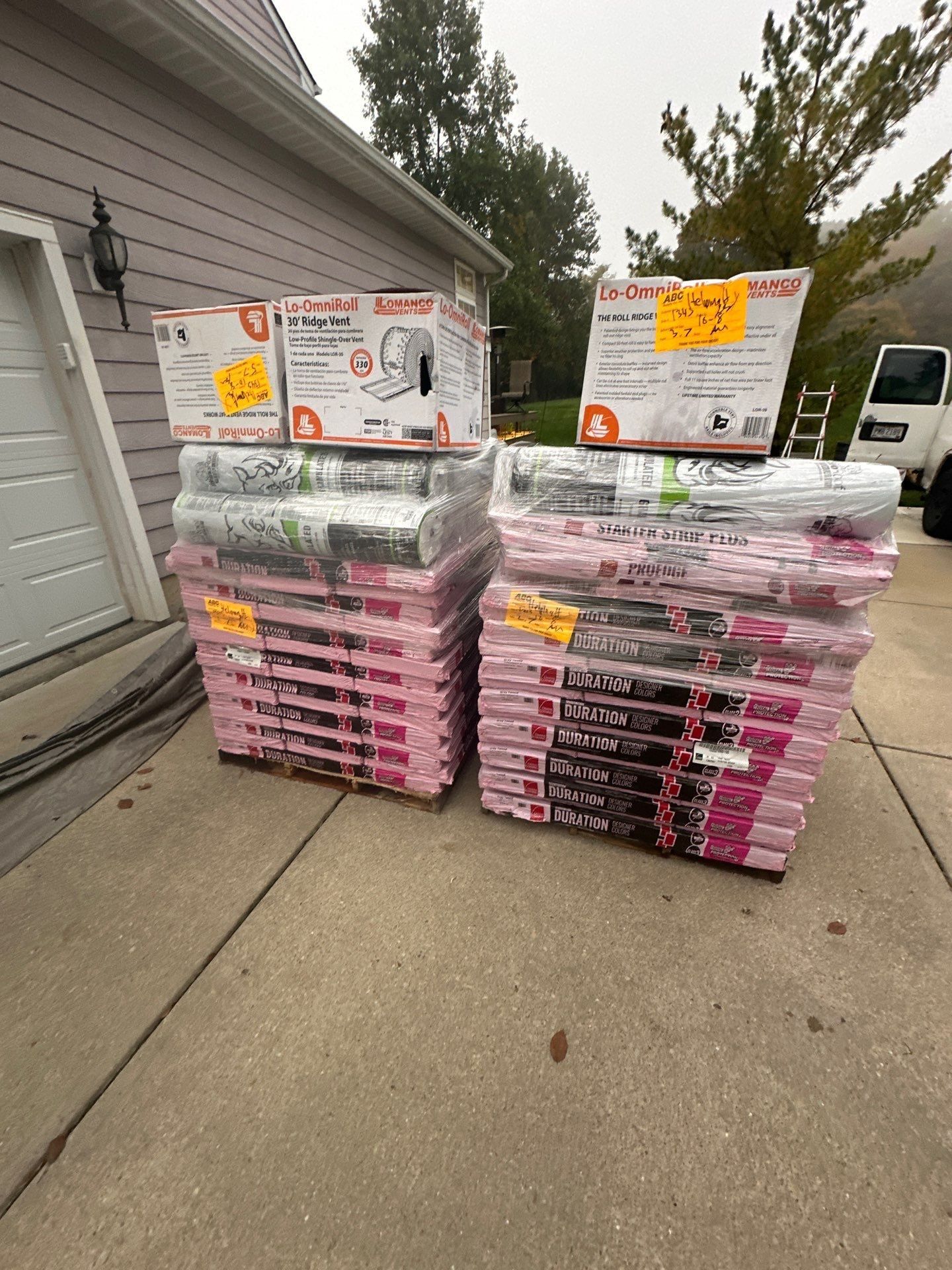 Pallets of new shingles and ridge vent boxes on the driveway, Beavercreek, Ohio.