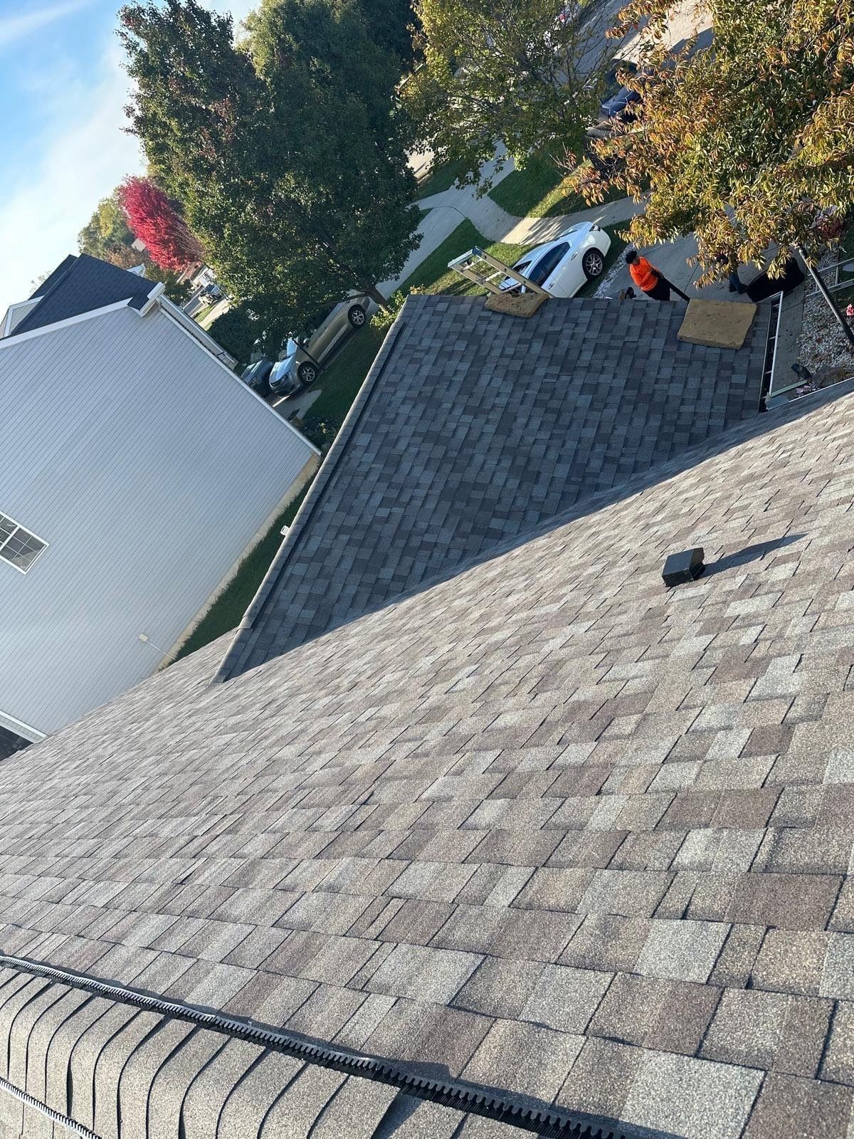 New shingles where two roof sections meet beside the two-story neighbor, Beavercreek, Ohio.