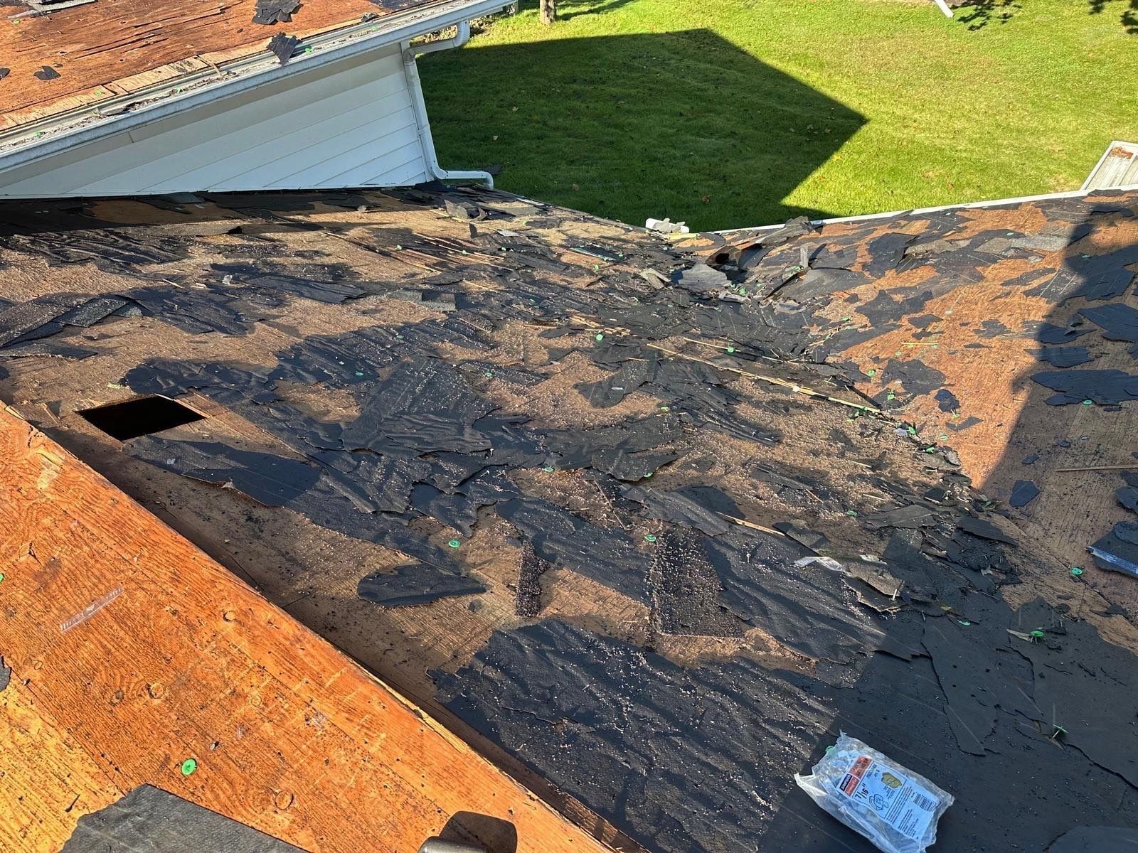Old underlayment and torn-off shingles on the deck near the eave, West Carrollton, Ohio.