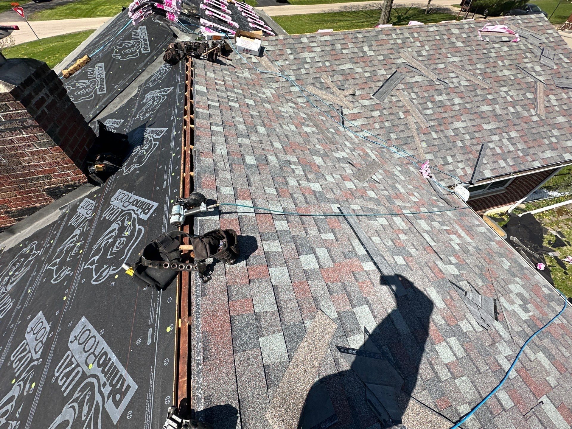 New multicolor shingles covering a slope with the ridge left open, Beavercreek, Ohio.