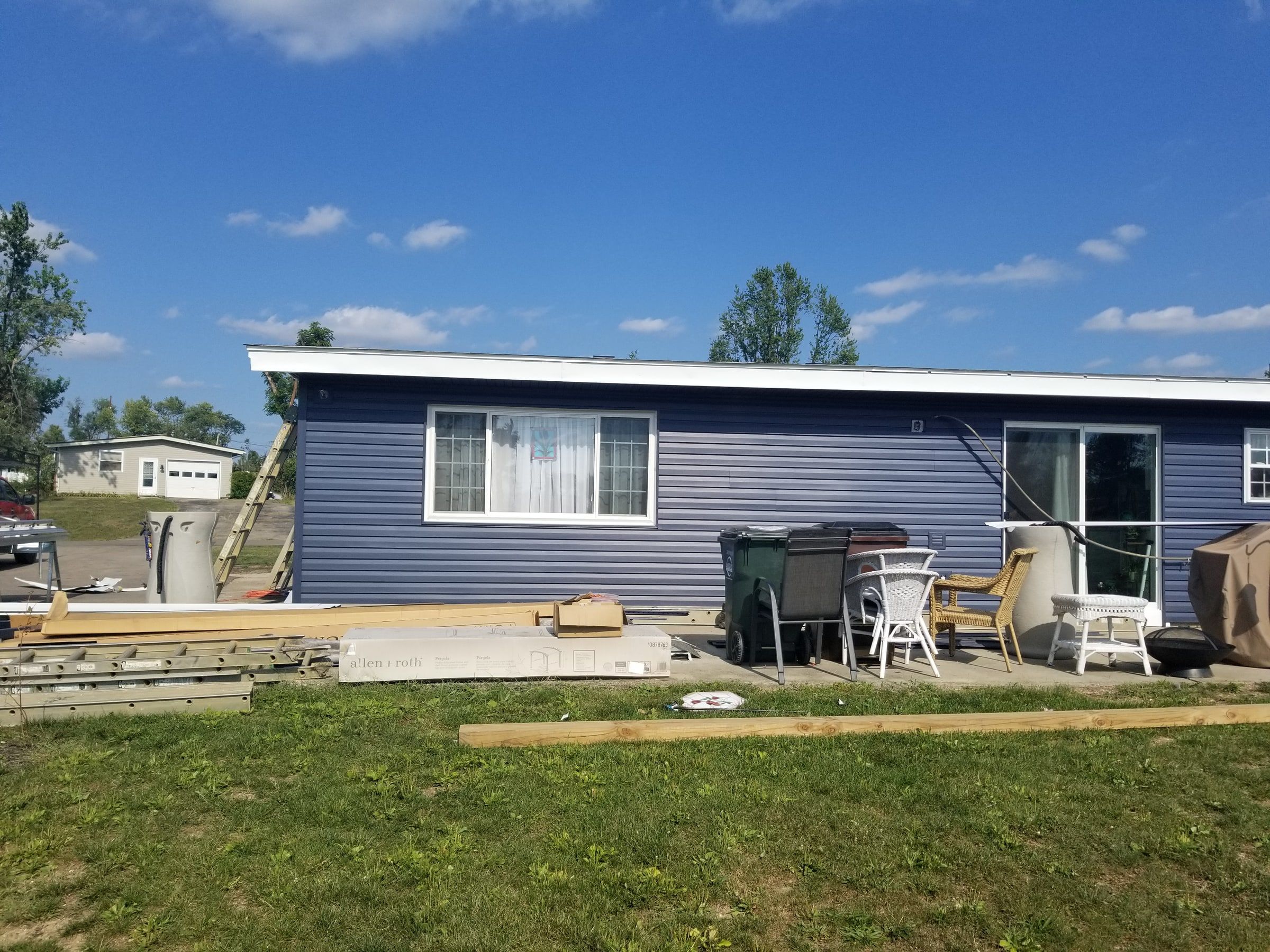 White custom bent metal at the roof edge above the new blue siding, Beavercreek, Ohio.