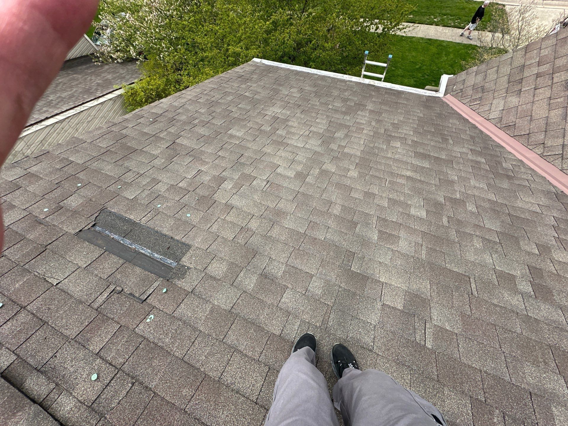 A creased shingle and a torn strip on the wind-damaged roof, Kings Mills, Ohio.