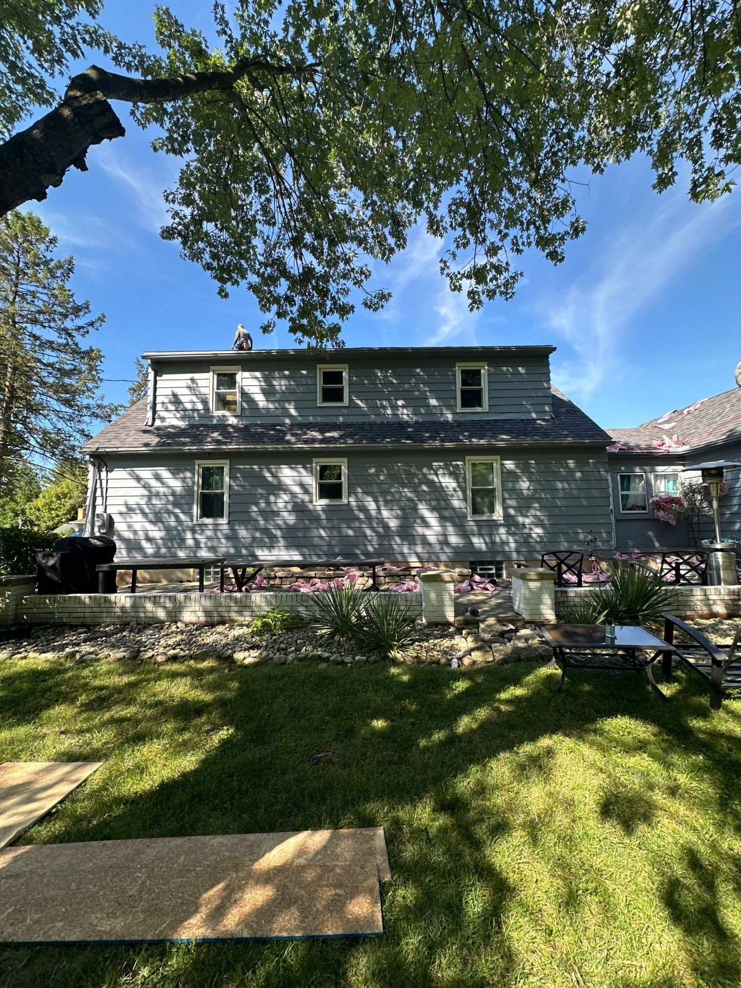 The back yard with a sheathing panel set on the lawn, Beavercreek, Ohio.