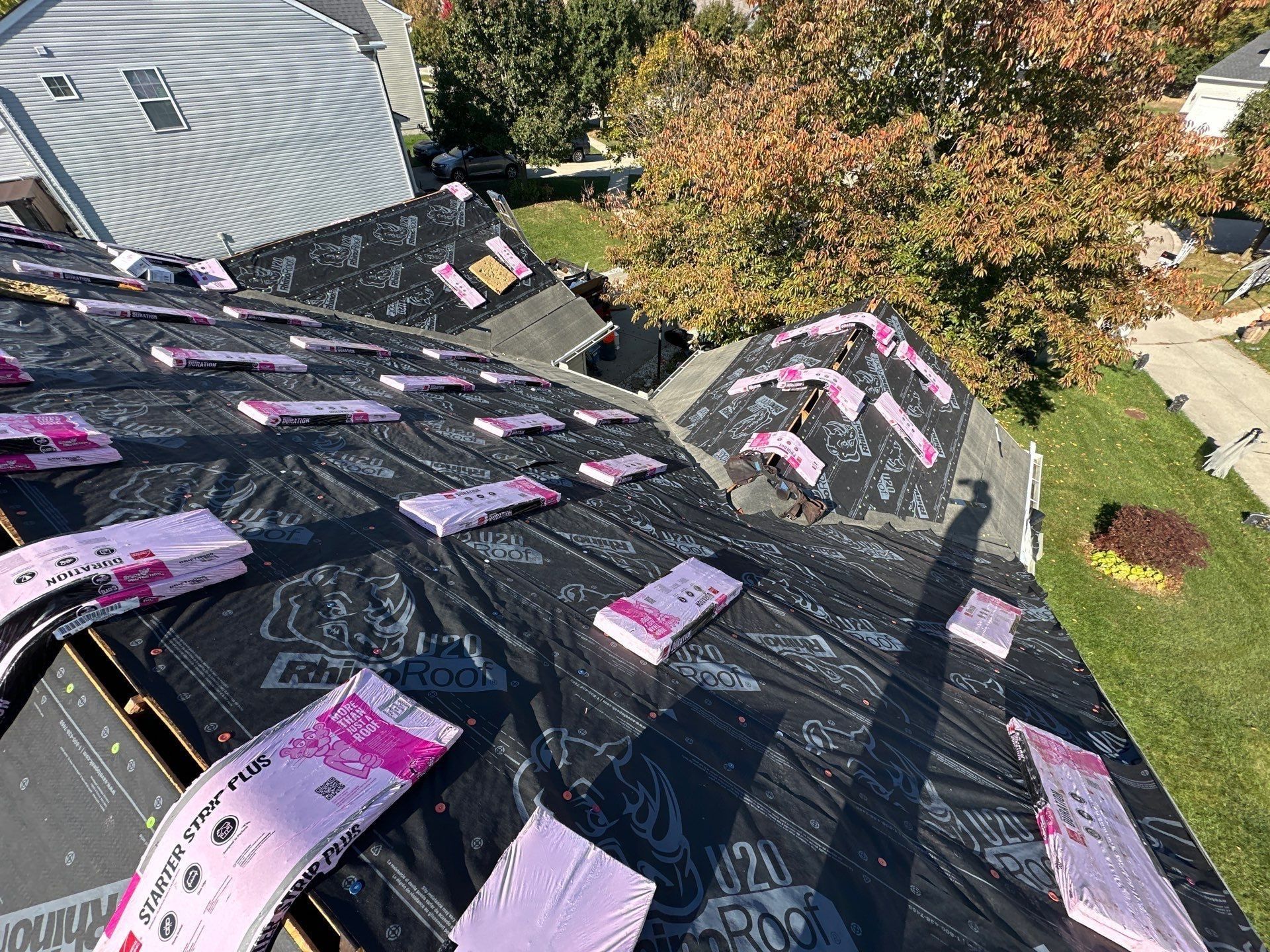 Shingle bundles and starter strips staged across the front slopes, Beavercreek, Ohio.