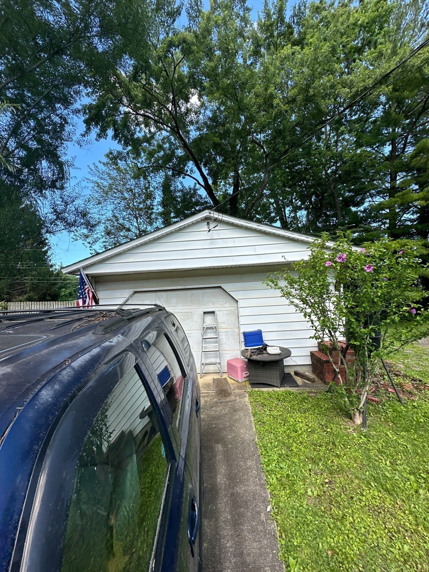 White detached garage and parked SUV