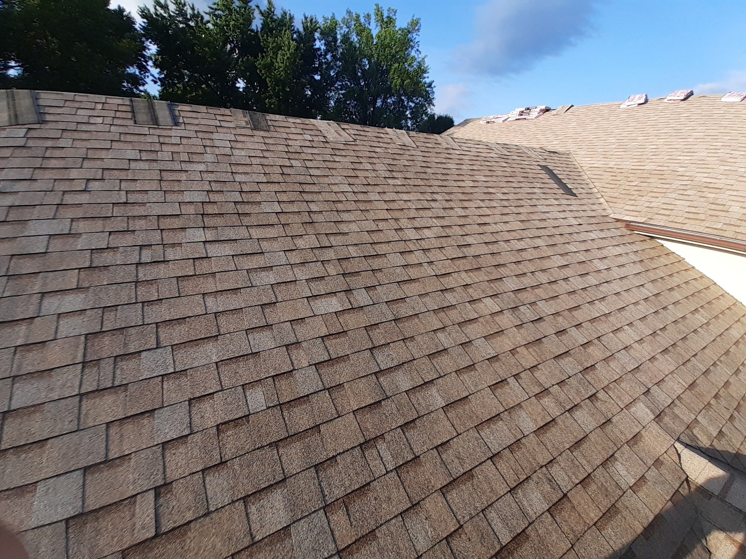 Freshly shingled slope with cap pieces waiting along the ridge, Jamestown, Ohio.