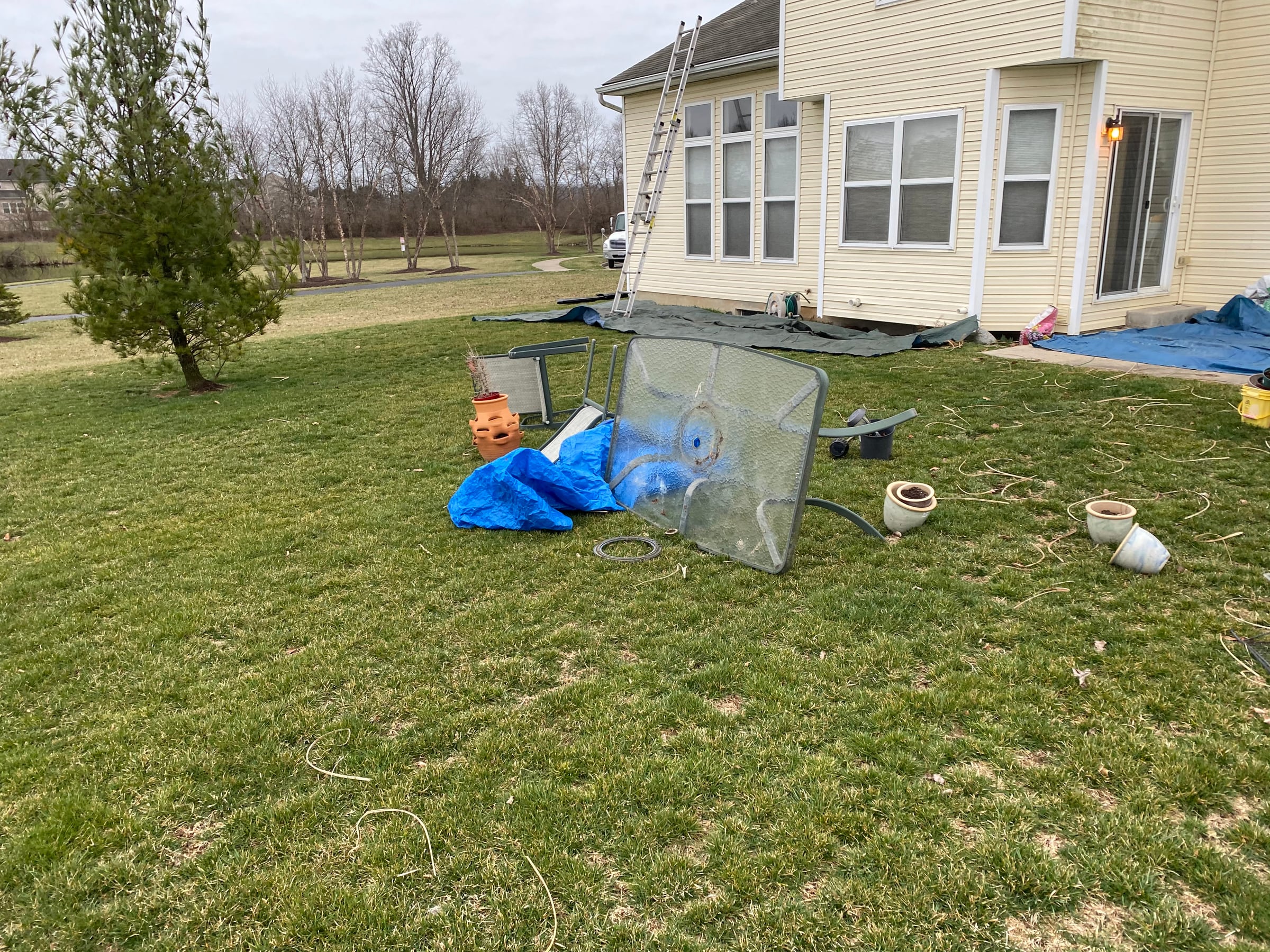 Ground tarp, patio table and pots