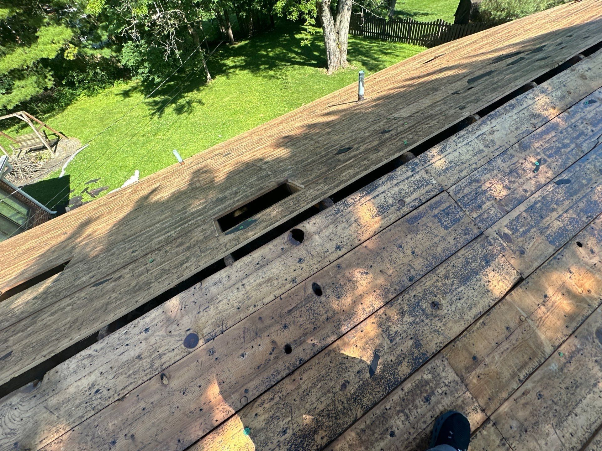 Gaps and broken spots in the old 1x board deck after tear-off, Beavercreek, Ohio.