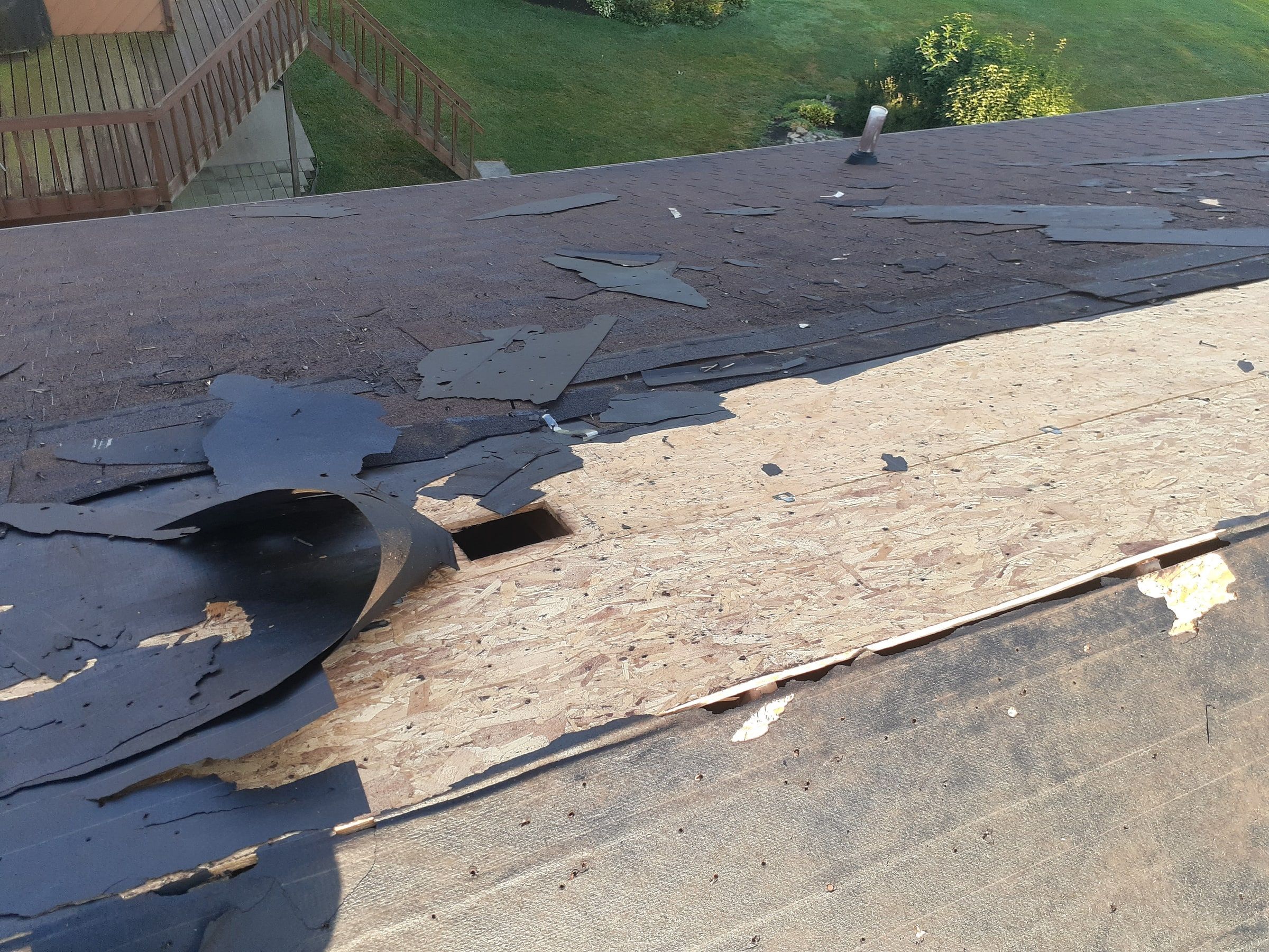 Torn old shingles curling back to expose the deck below, Jamestown, Ohio.