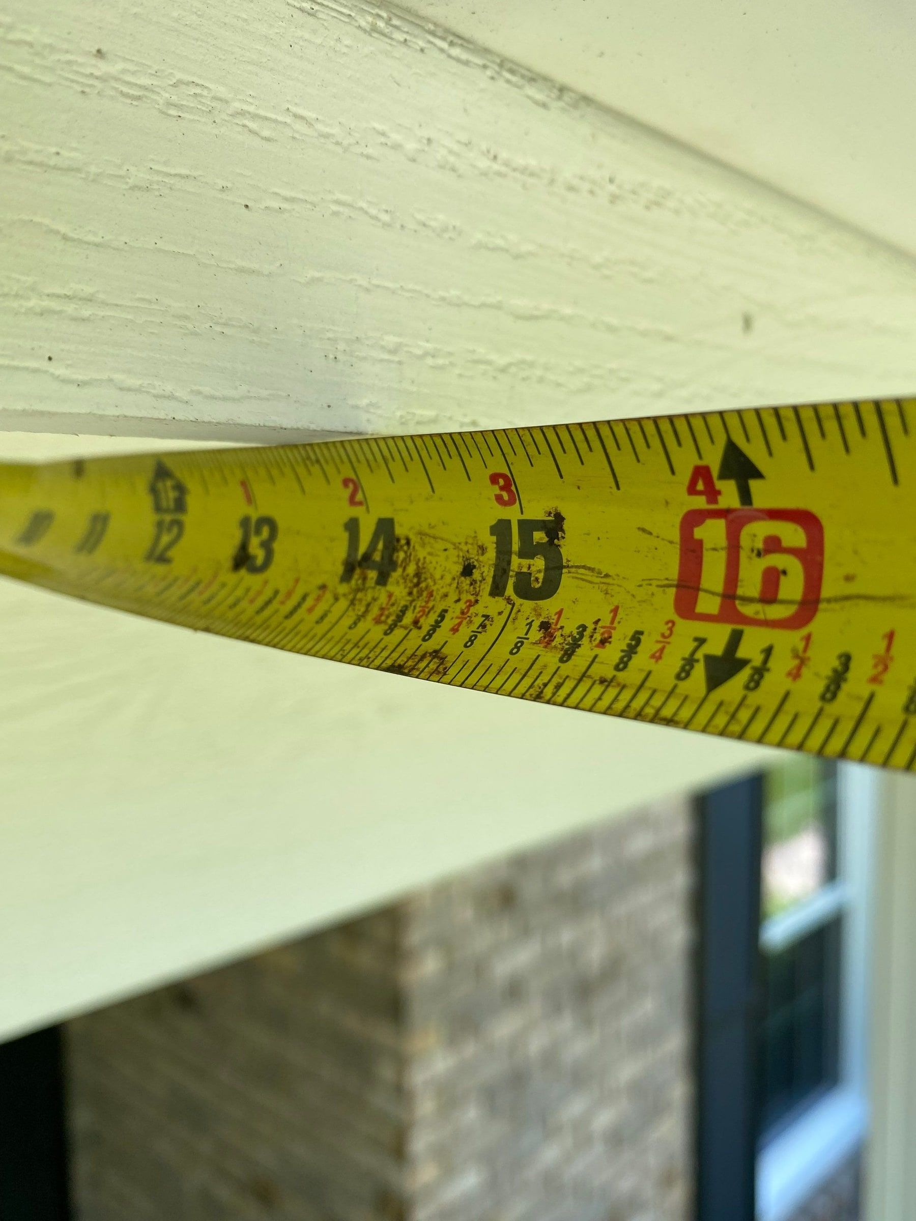 Tape measure checking the overhang beneath the soffit, Yellow Springs, Ohio.