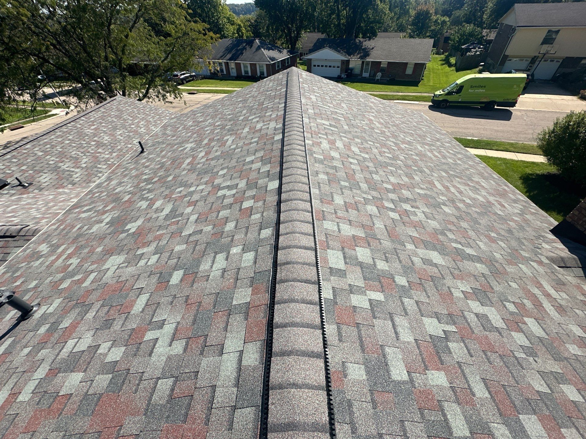 Ridge vent along the finished hip roof, with the street below, West Carrollton, Ohio.