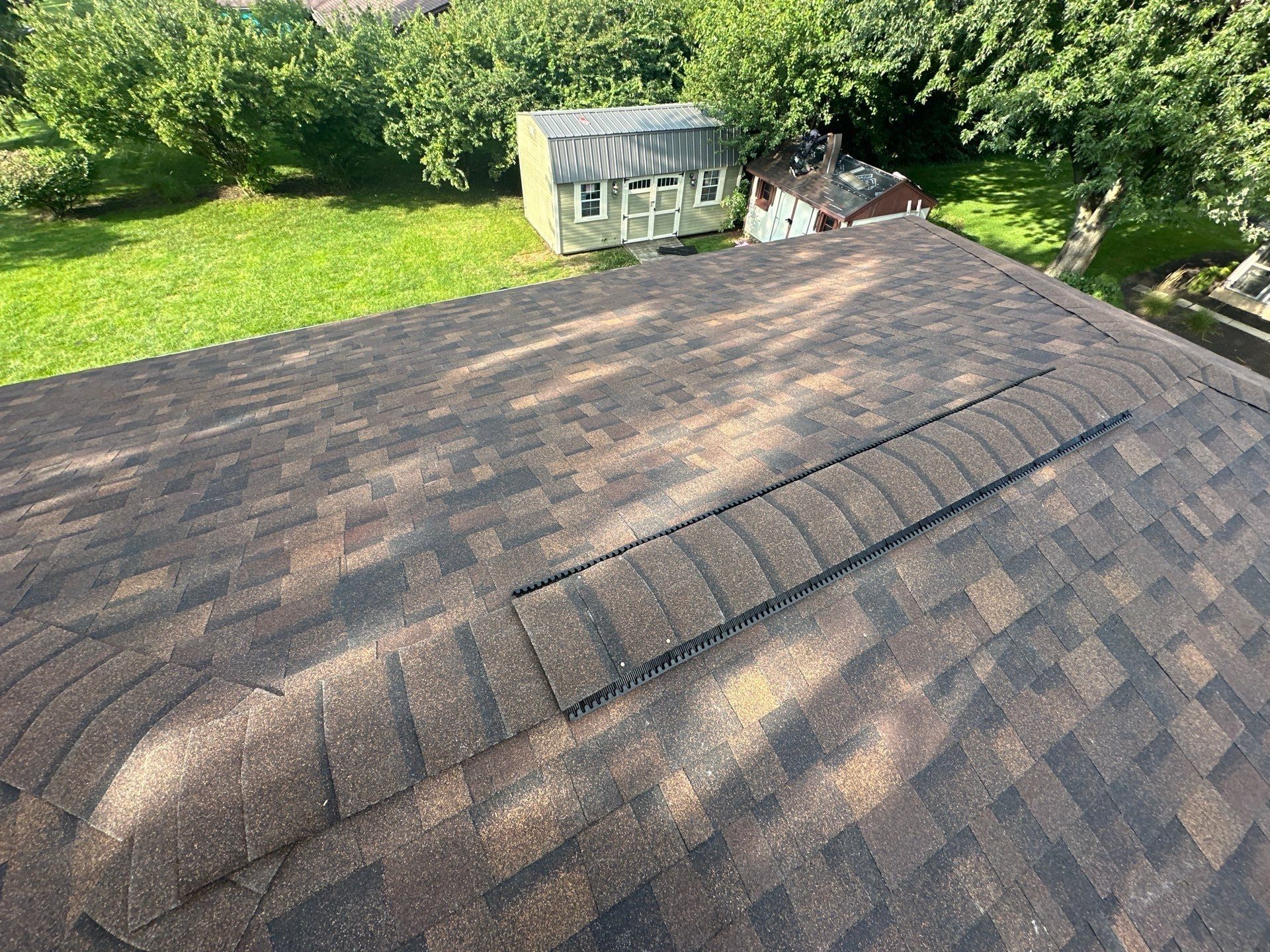The finished back slope with a run of ridge vent, above the shed, Dayton, Ohio.