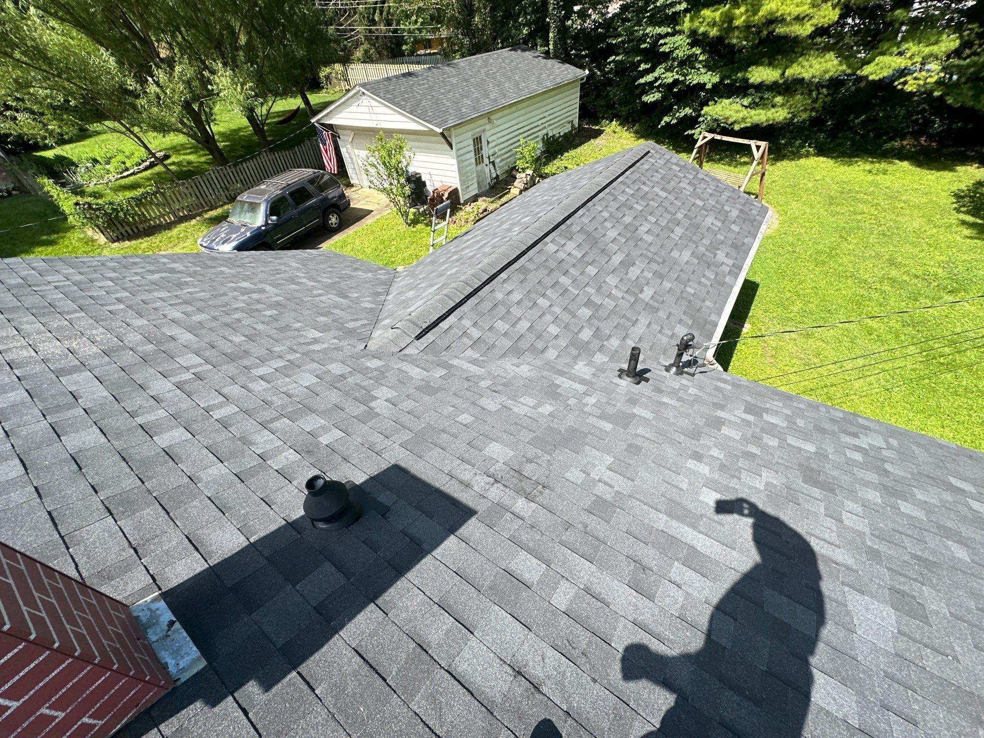 The finished house roof and valley, with the garage's new roof beyond, Beavercreek, Ohio.