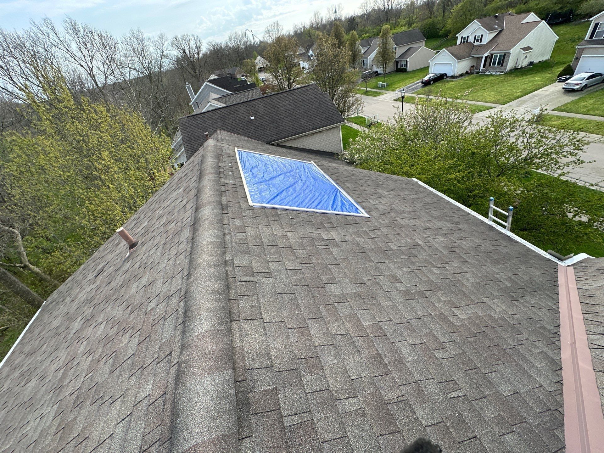 The emergency tarp fastened over a damaged section of the roof at the time of inspection.