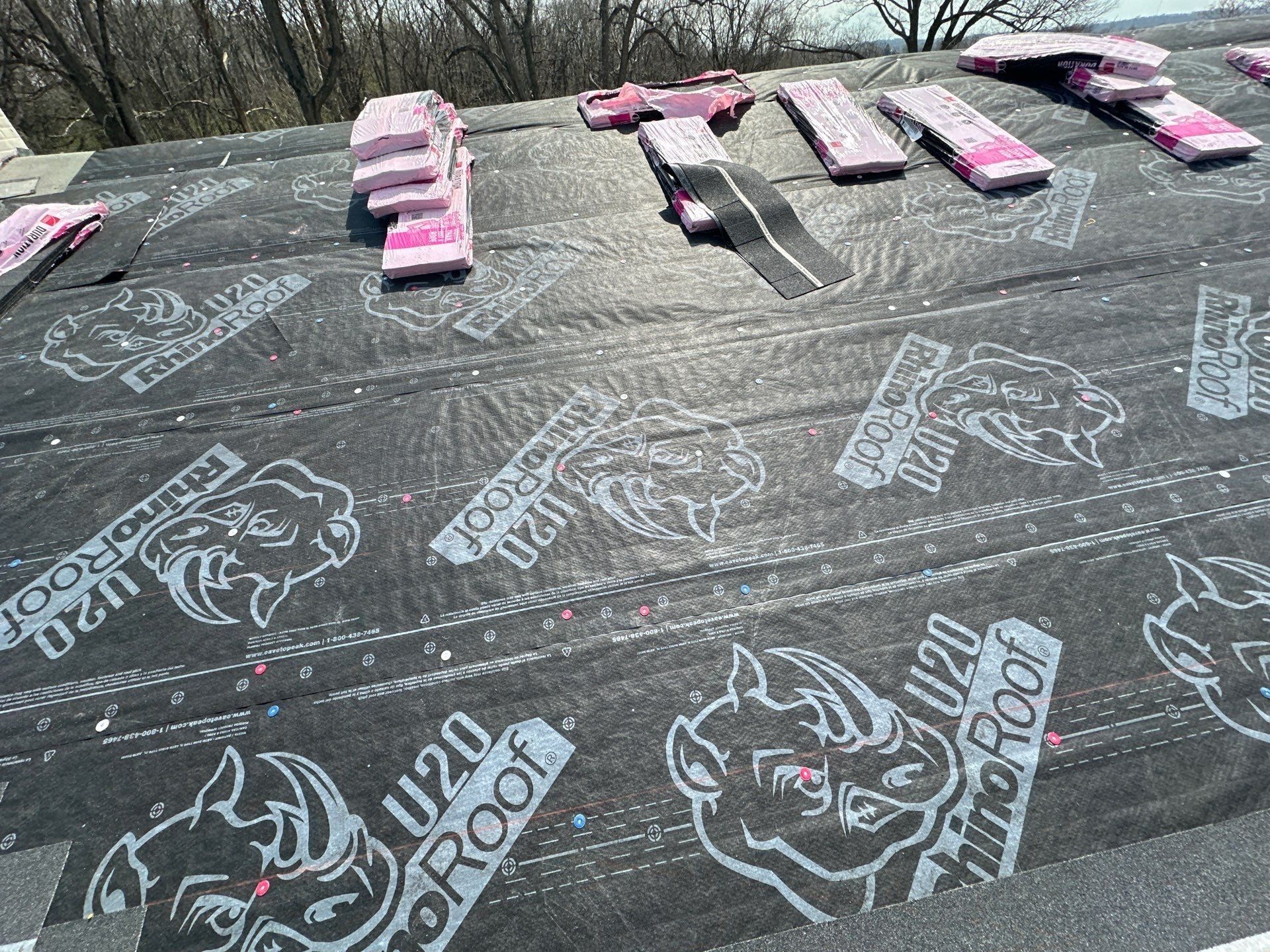 Shingle bundles staged across the RhinoRoof underlayment, Dayton, Ohio.