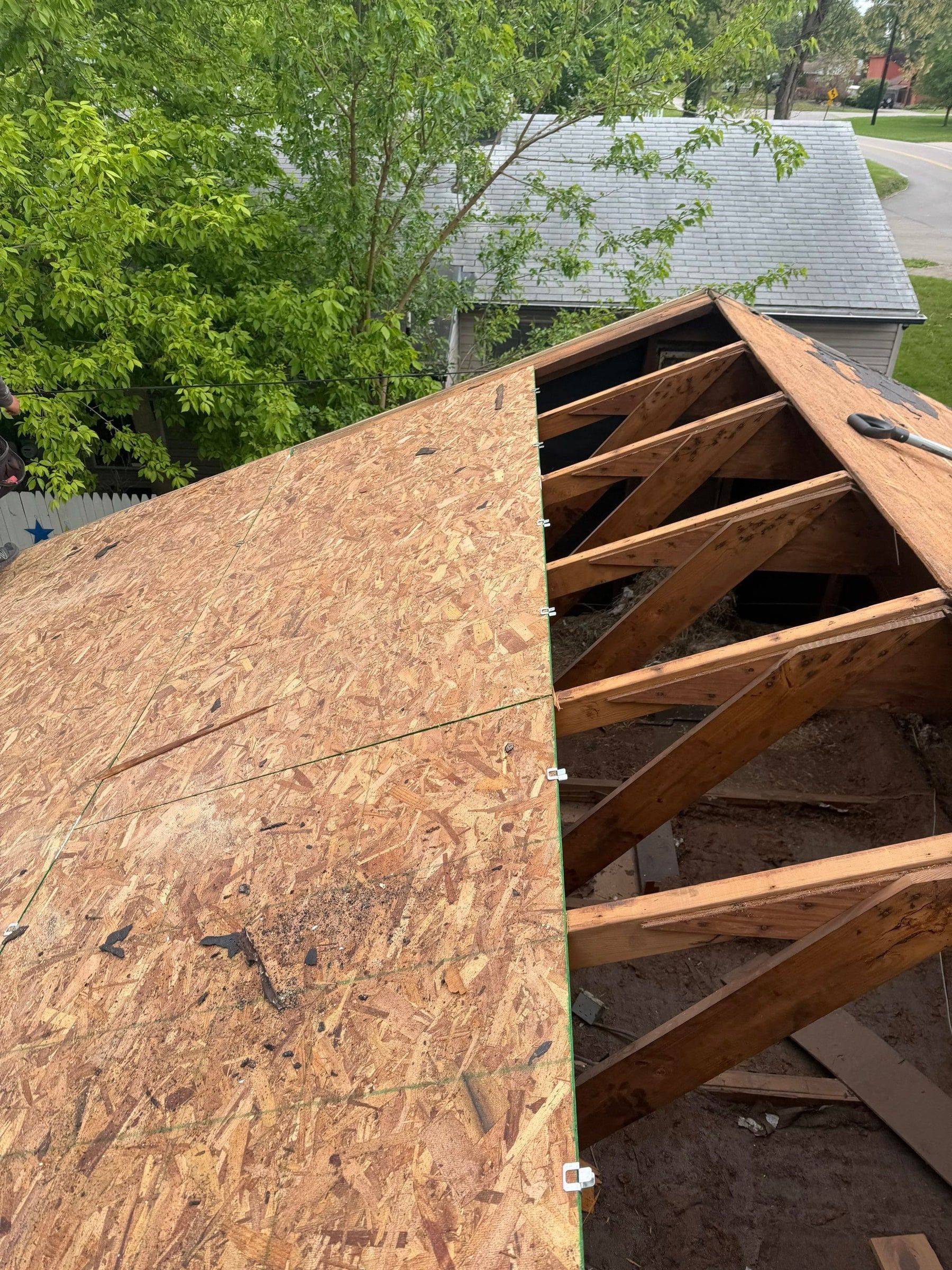 Old sheathing removed at the end of the roof, new OSB going on beside it, Dayton, Ohio.