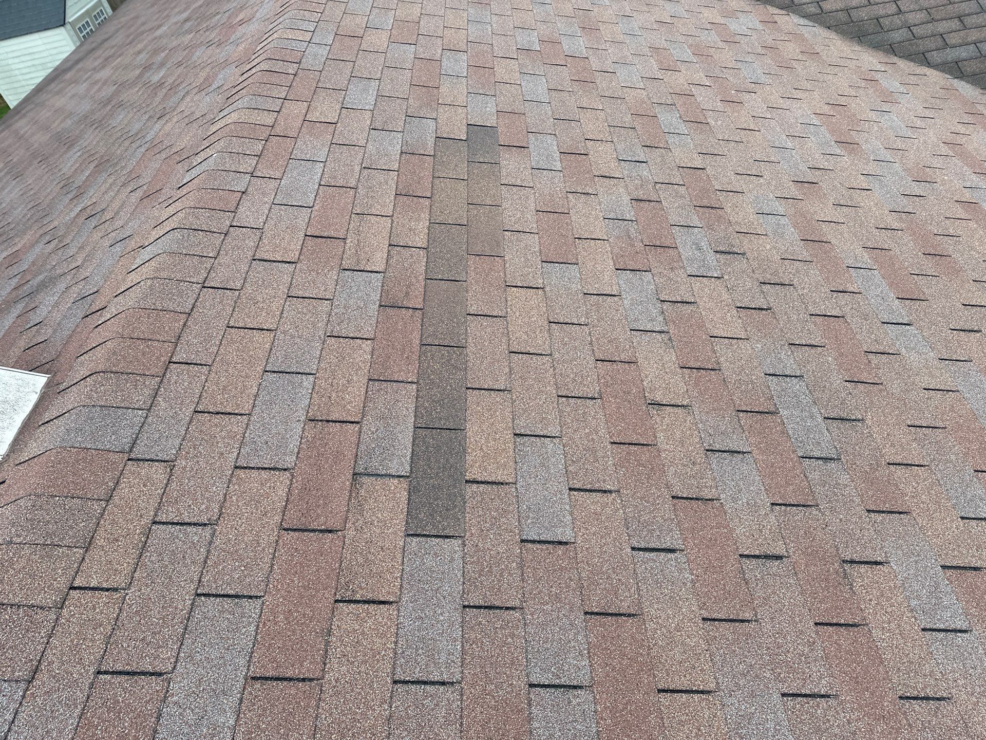A column of darker replacement shingles in the old roof, Beavercreek, Ohio.