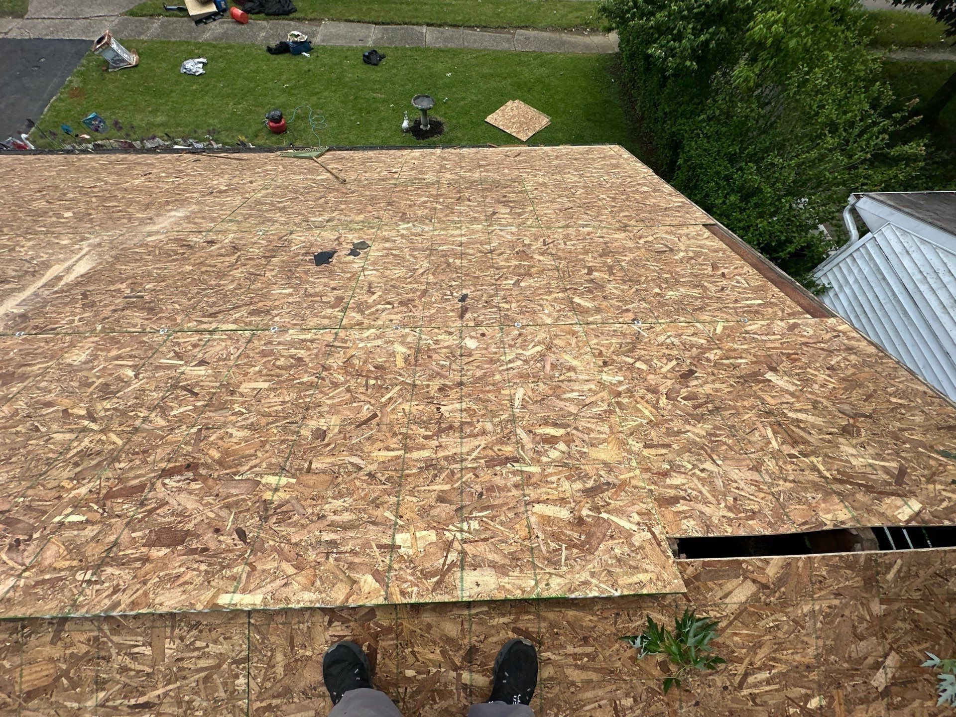New OSB sheathing down the back of the roof, with the photographer's feet at the ridge, Dayton, Ohio.
