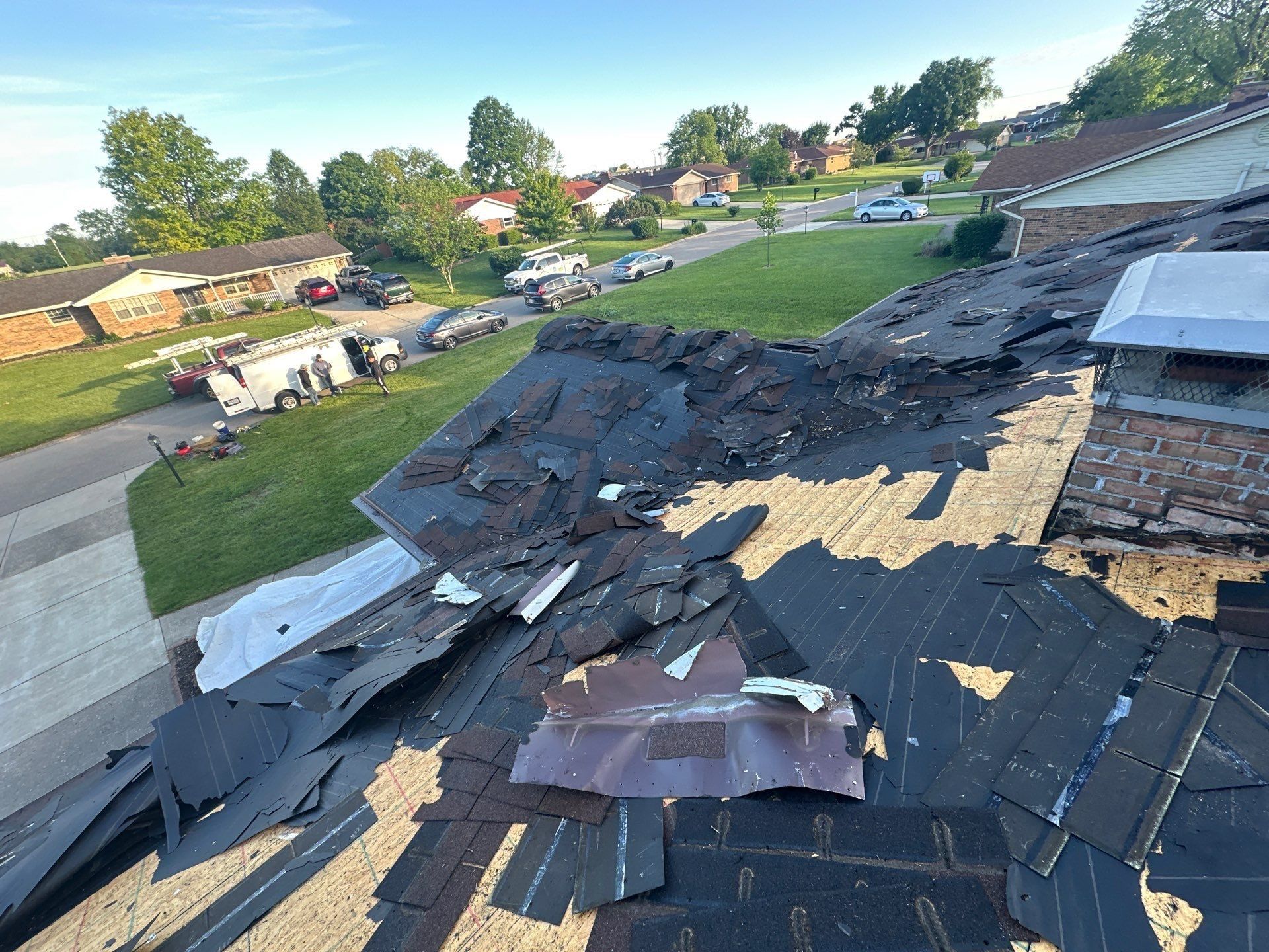 Torn-off shingles piled up around the chimney, Beavercreek, Ohio.