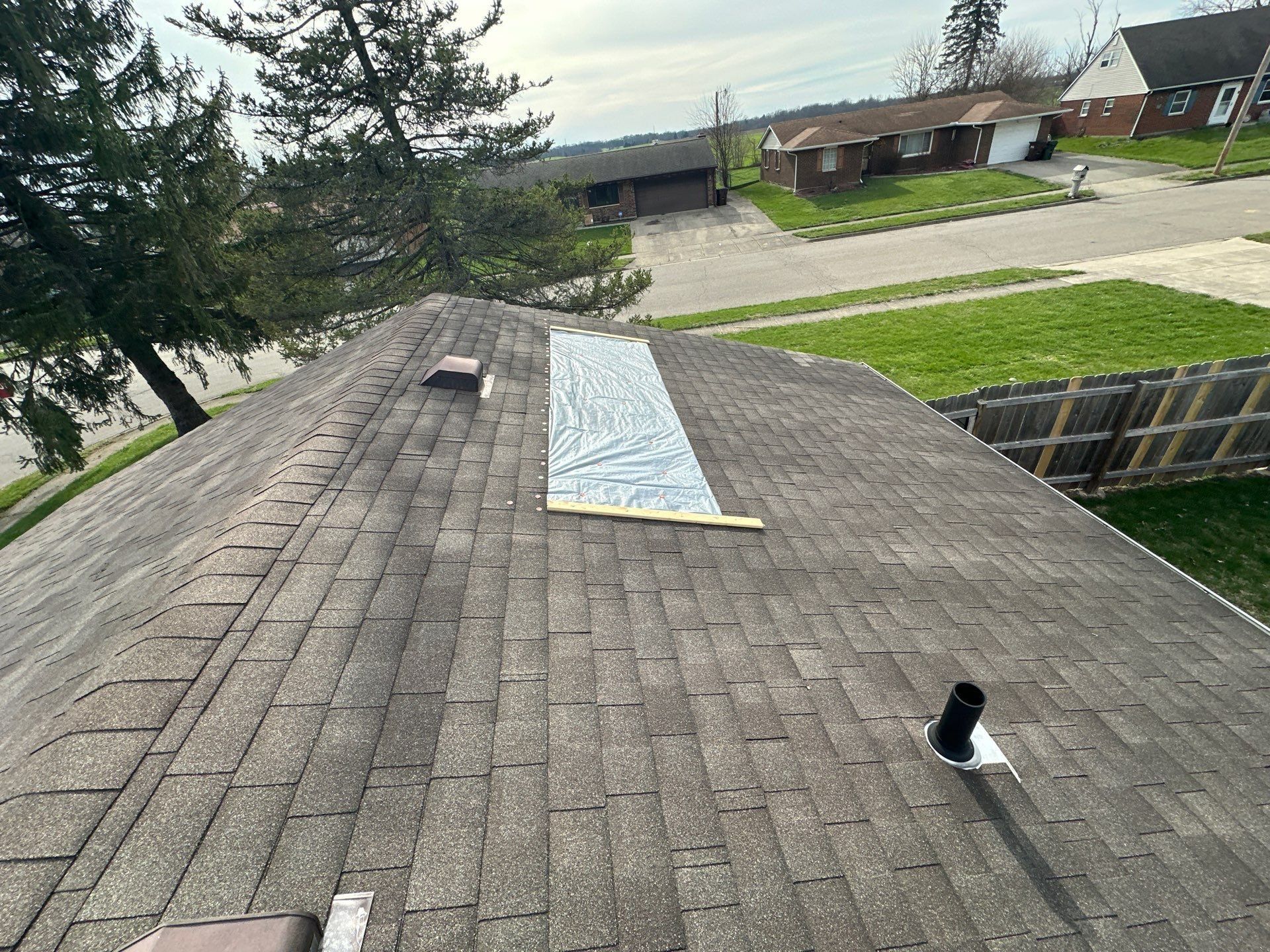 A tarp held down with boards on the roof, Xenia, Ohio.