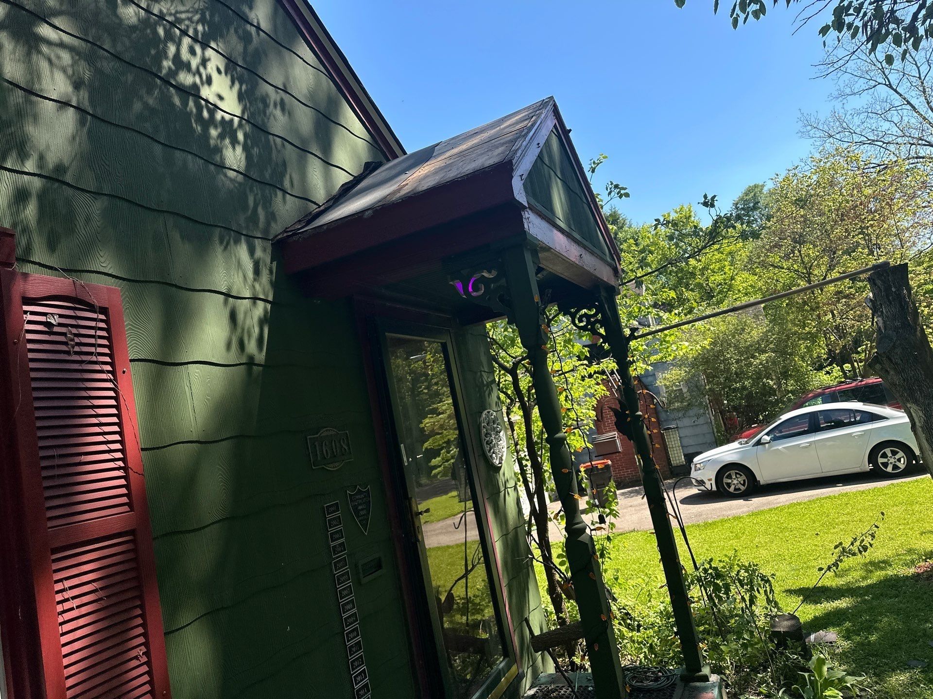 Porch entry canopy and parked car