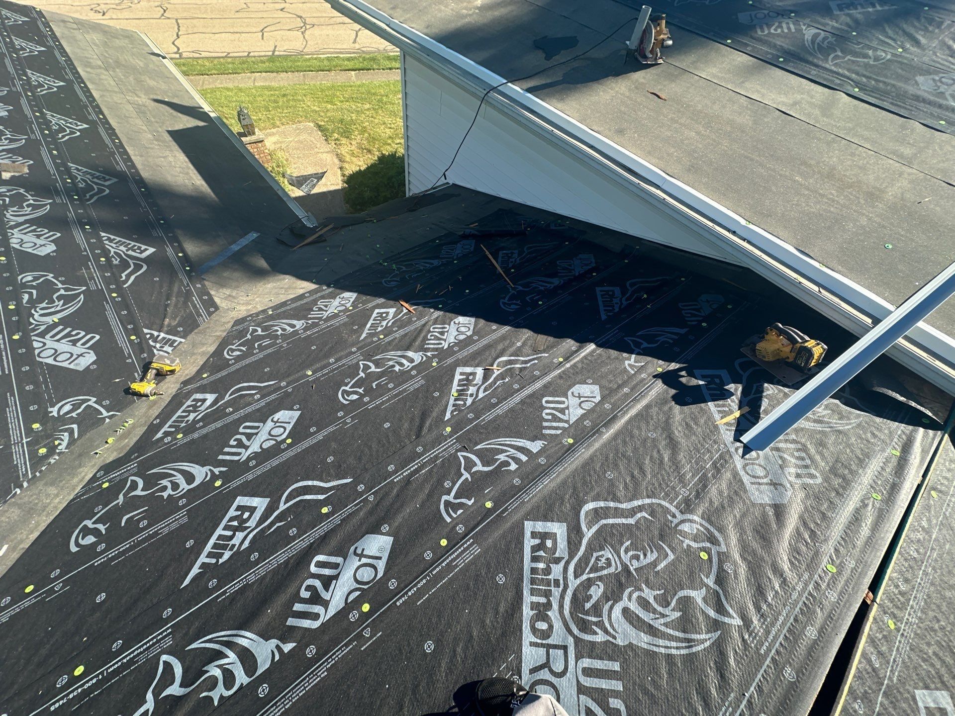 Synthetic underlayment run up to the siding where the roof meets the wall, West Carrollton, Ohio.