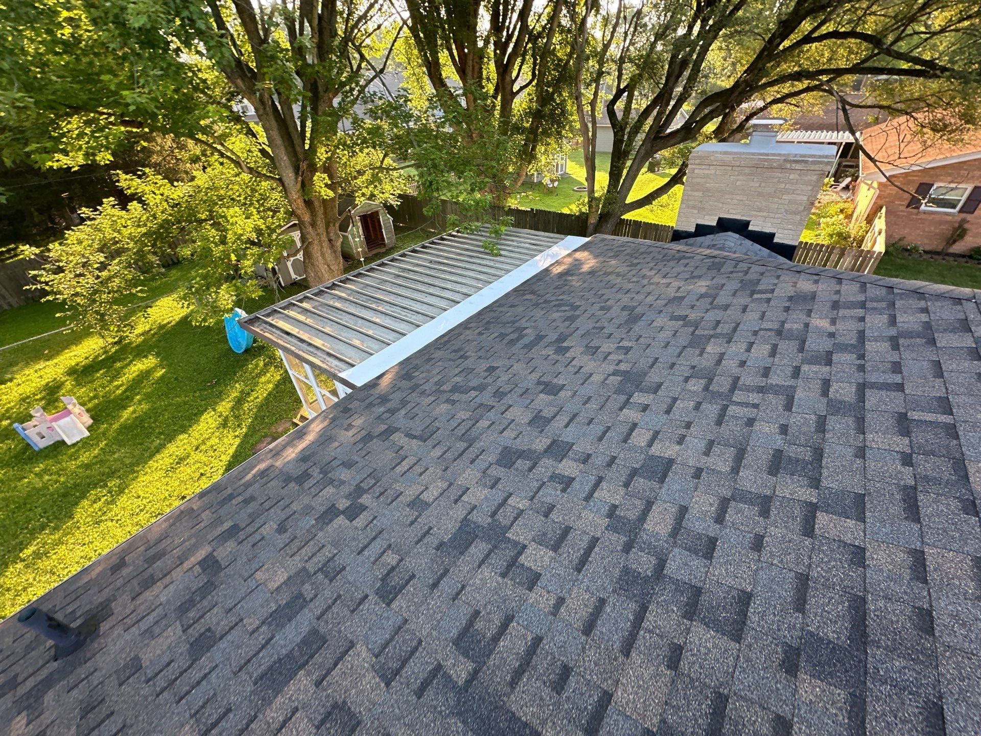Completed slope meeting the sunroom roof trimmed in white metal, Beavercreek, Ohio.
