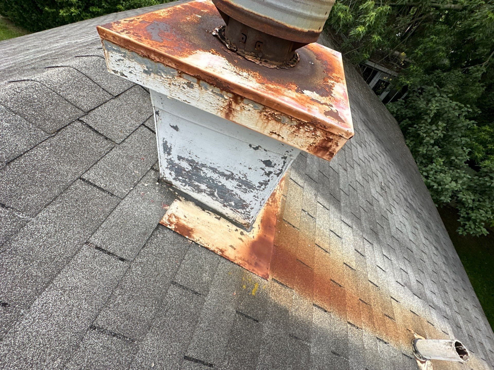 The rusted metal box built to look like a chimney, on the old roof, Dayton, Ohio.